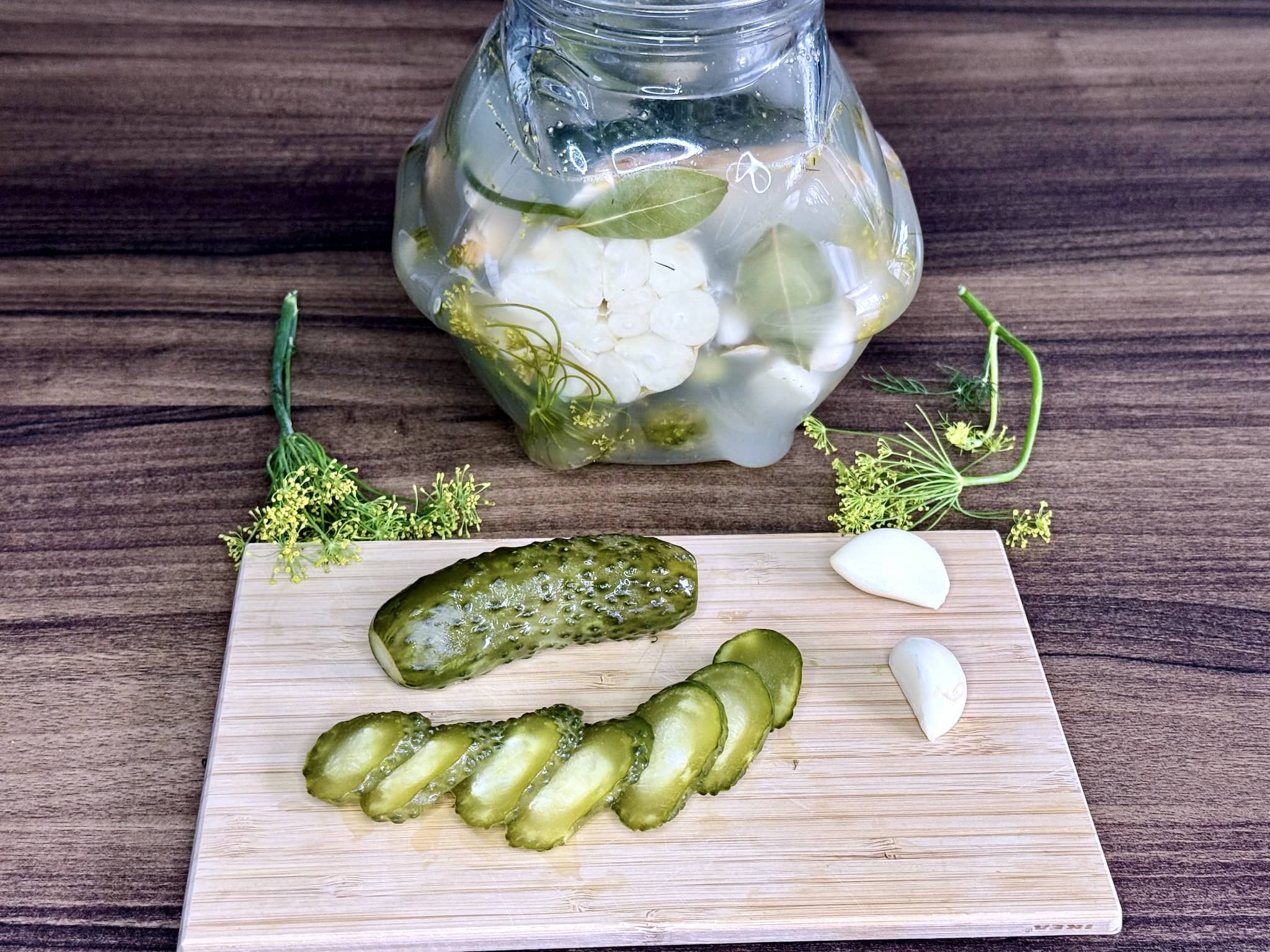 A jar after 72 hours with a sliced cucumber on a chopping board