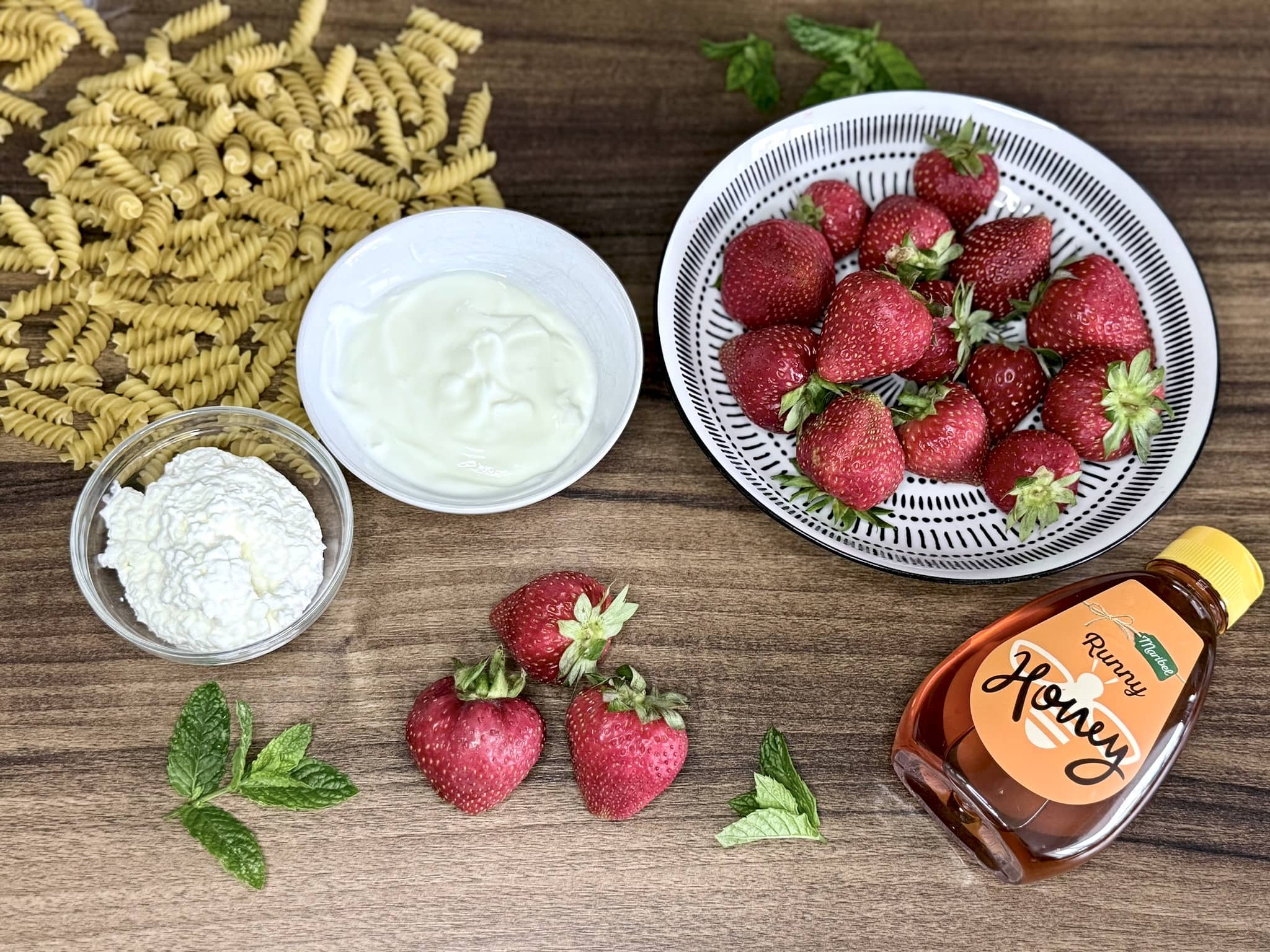 All the ingredients on a table top ready to make strawberry pasta