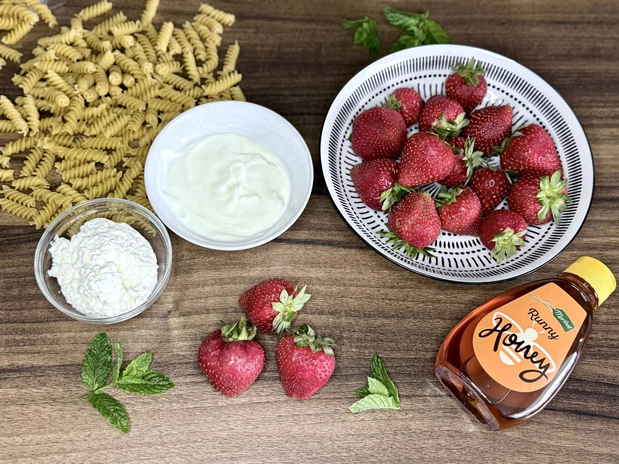 All the ingredients on a table top ready to make strawberry pasta