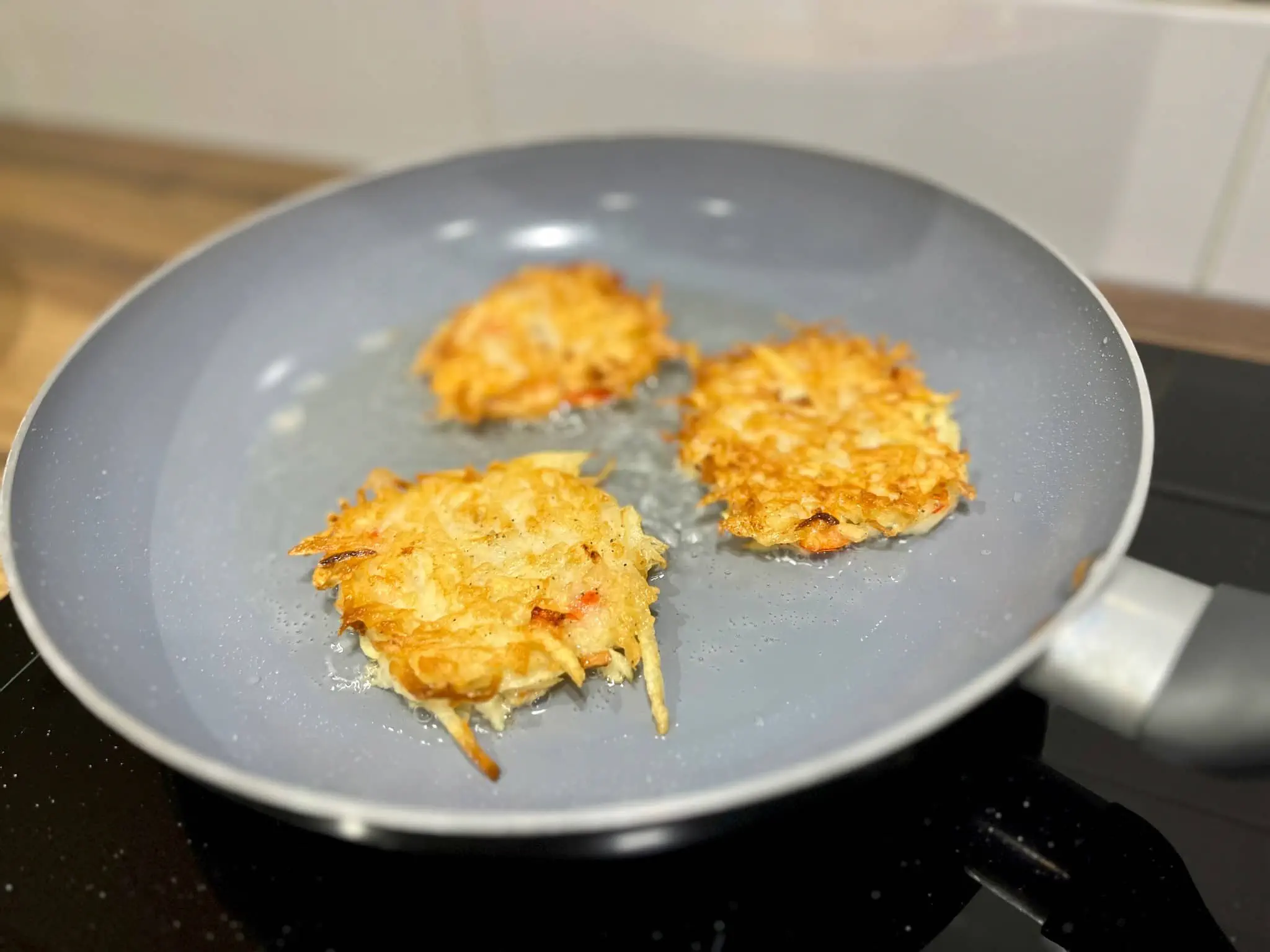 Golden pancakes sizzle in a pan