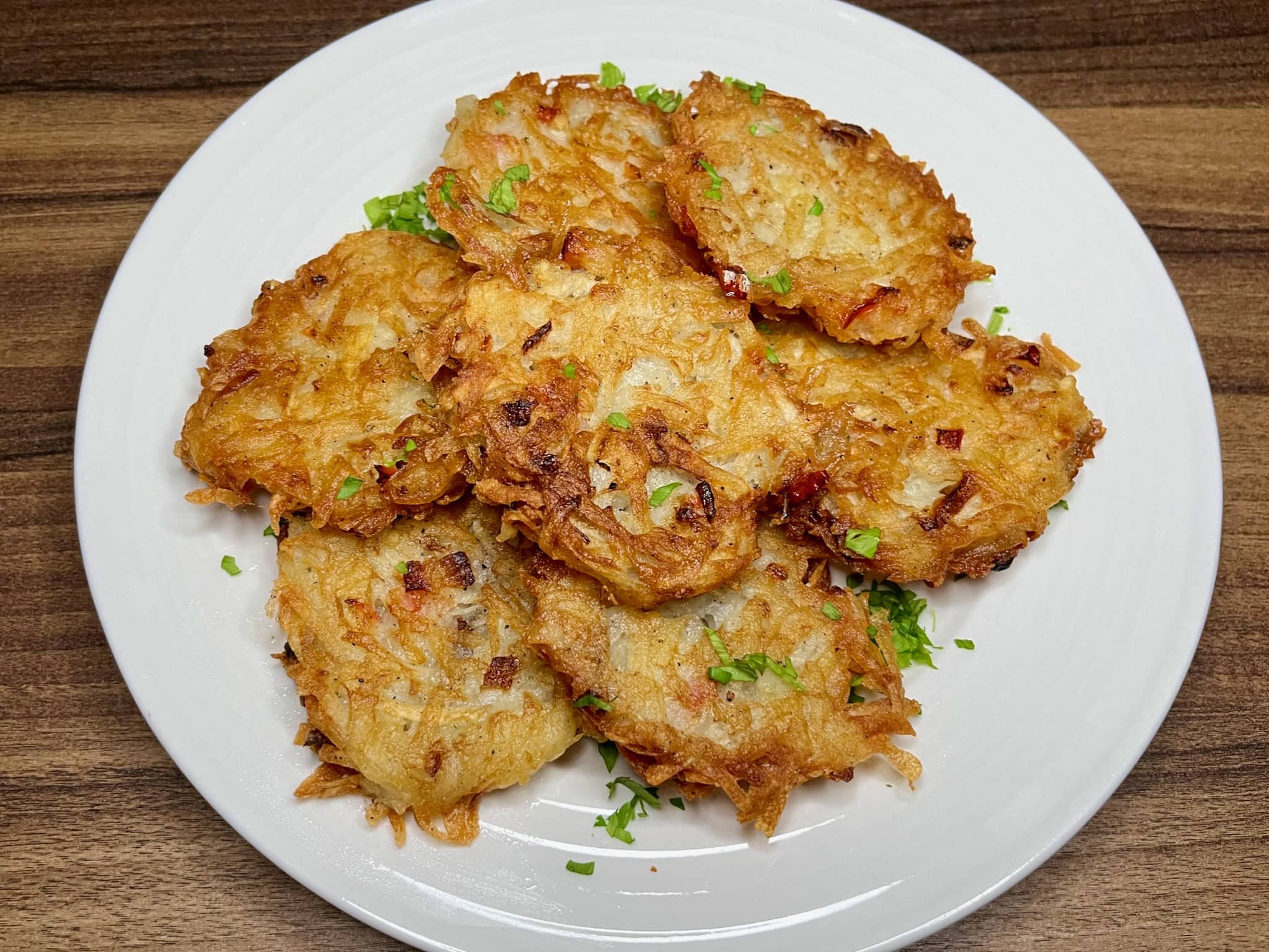 Golden brown Polish-style potato pancakes are neatly arranged on a plate
