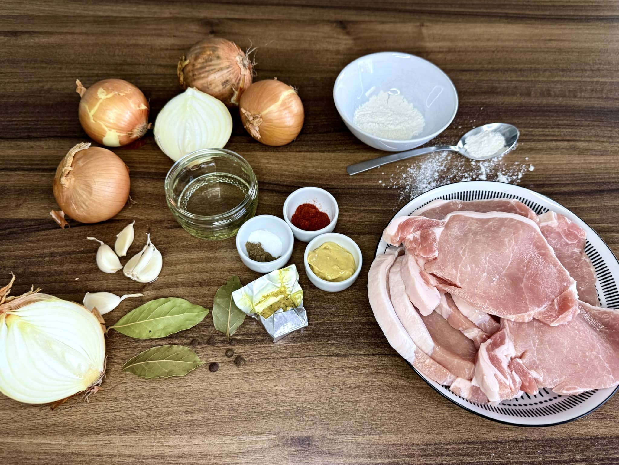 All ingredients on a tabletop ready to make Pork Chops in Onion Sauce