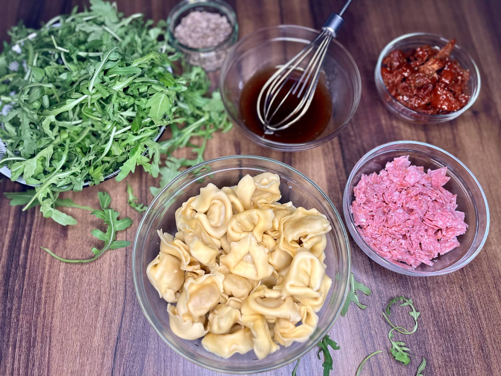 All the ingredients on a tabletop ready to make Tortellini Salad