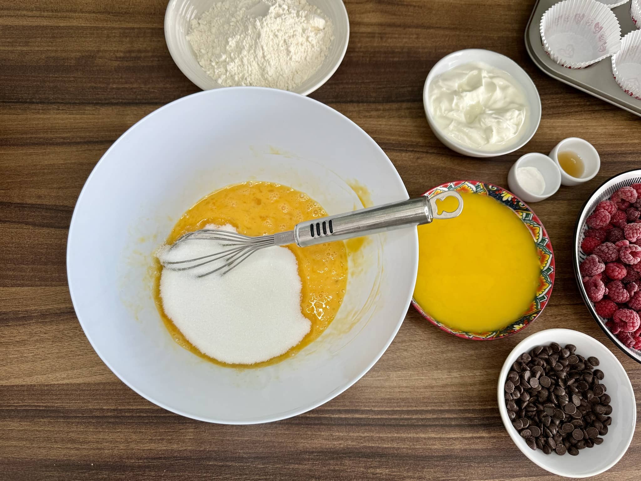 Mixing eggs with sugar in a mixing bowl
