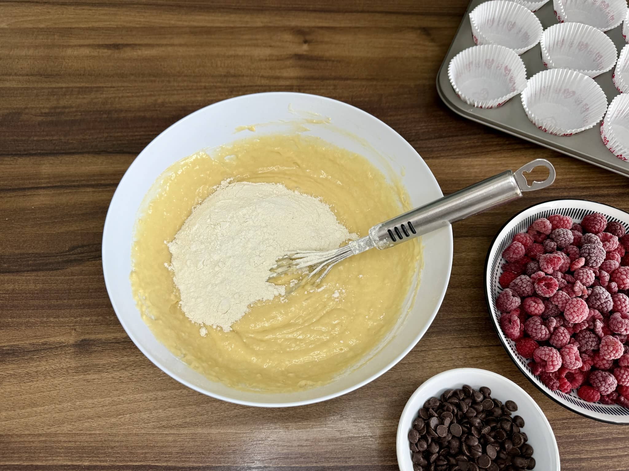 Adding flour to the mixture and continue mixing