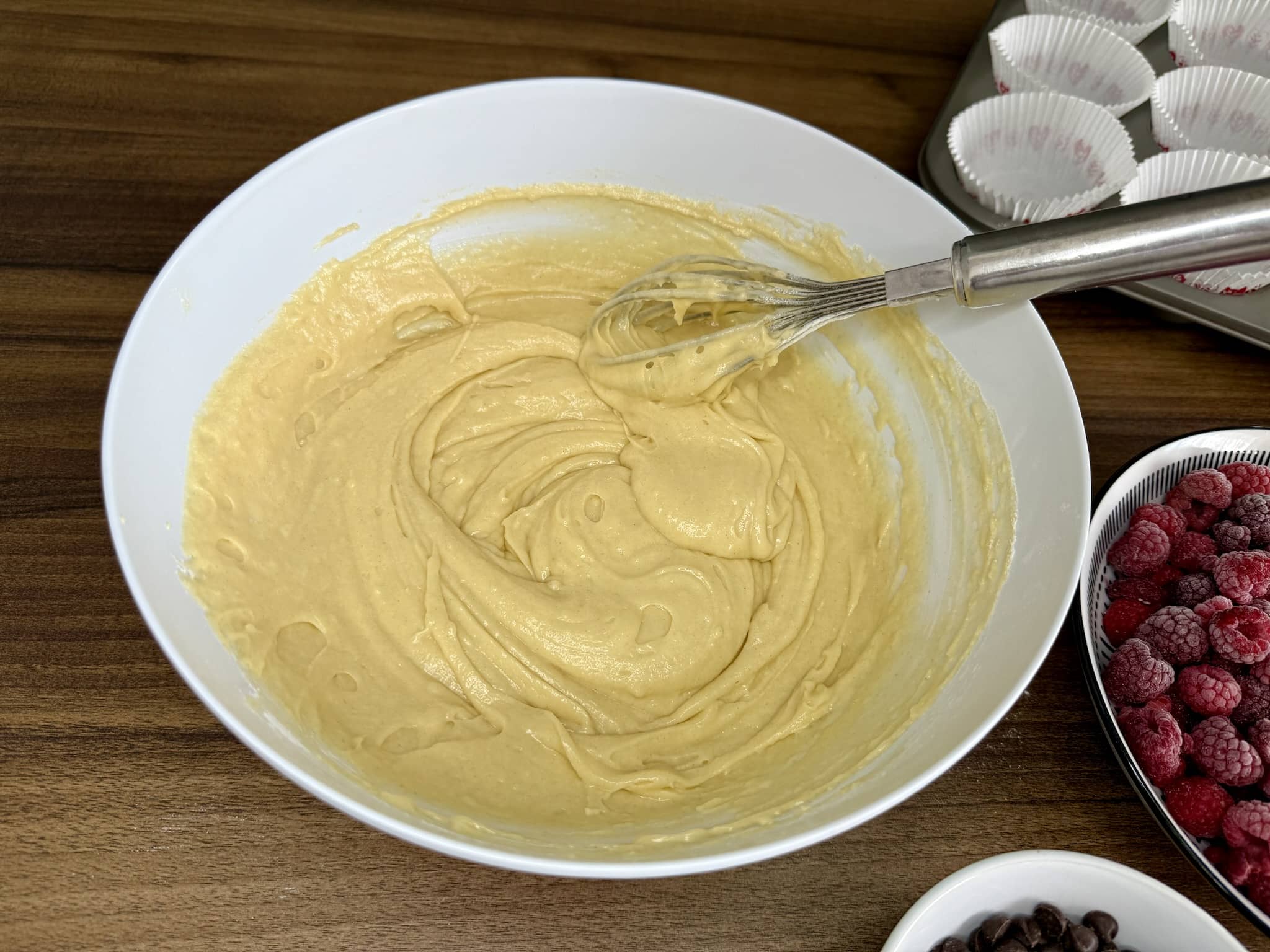 Nicely mixed batter for muffins ready to add raspberries and chocolate chips
