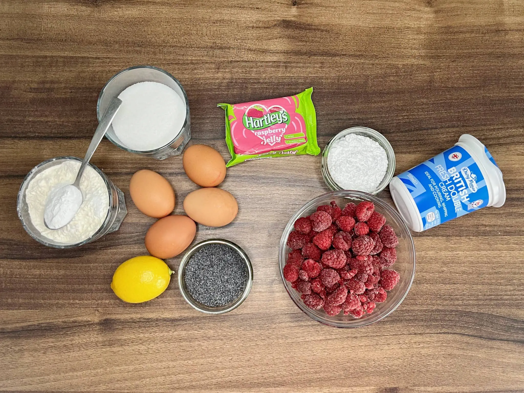 All ingredients on the tabletop are ready to make Raspberry Cake Pudding