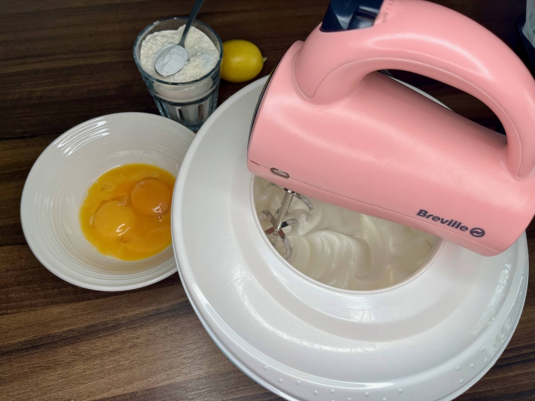 Mixing egg whites in a mixing bowl using a hand mixer