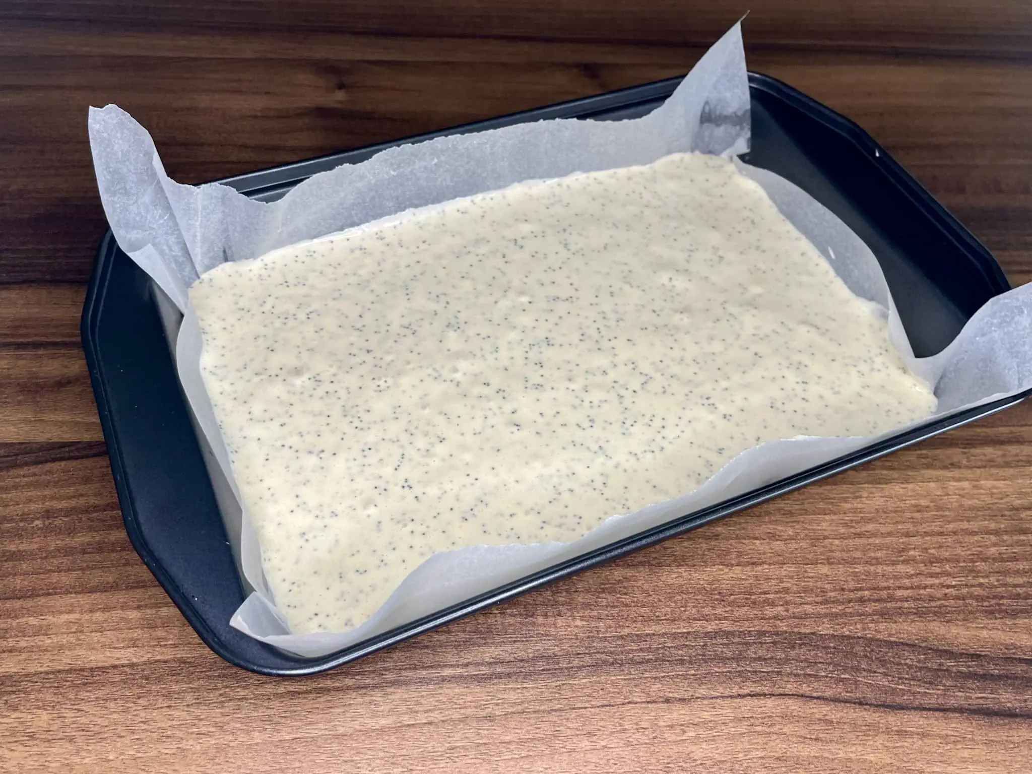 The cake mixture is placed in a tin before baking