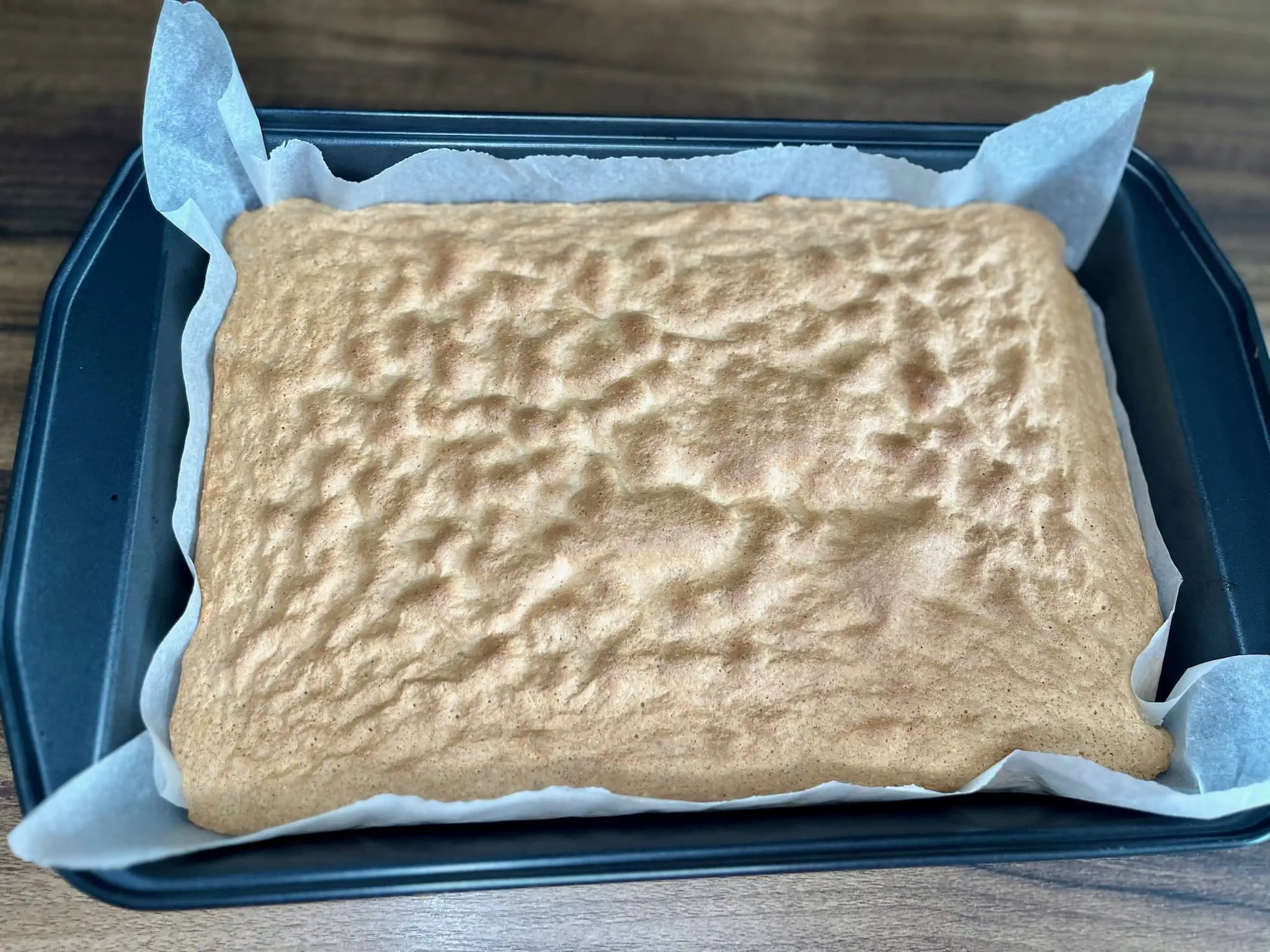 Baked cake in a tin taken from the oven