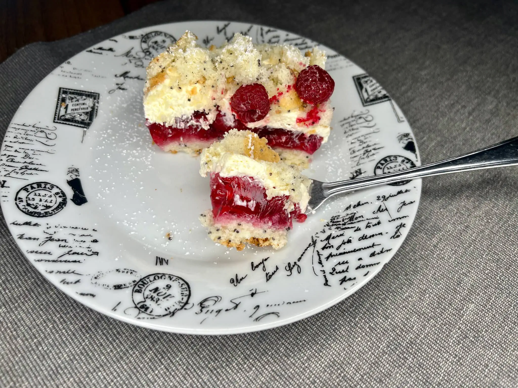 Piece of Raspberry Cake Pudding on a plate with a portion of it on a fork