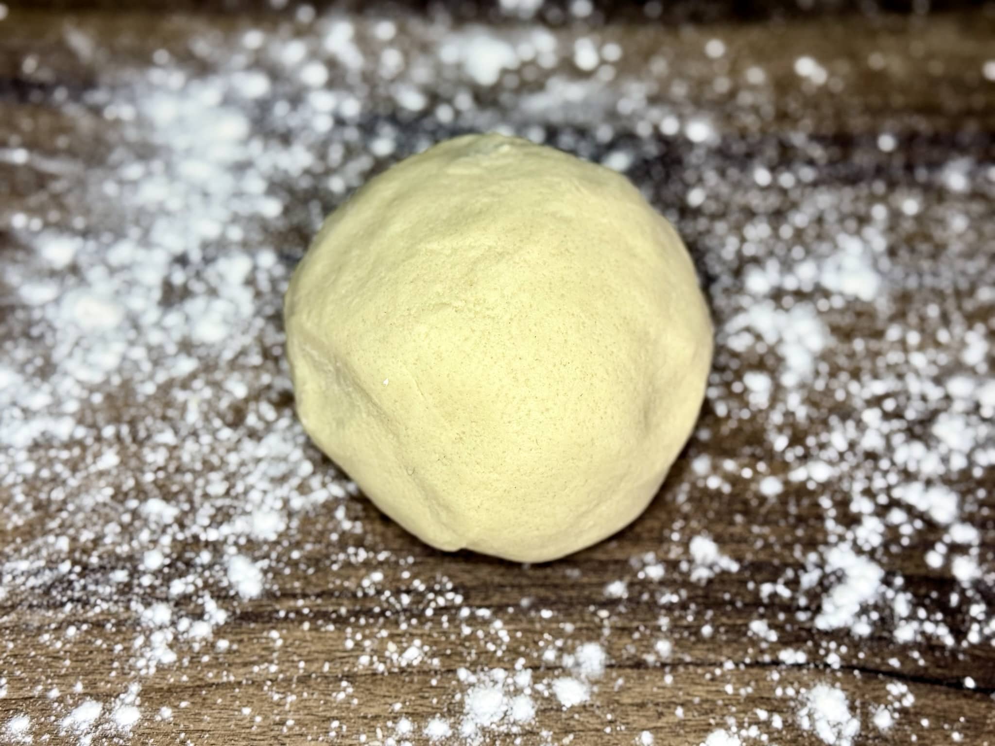 A dough ball on a lightly floured table top