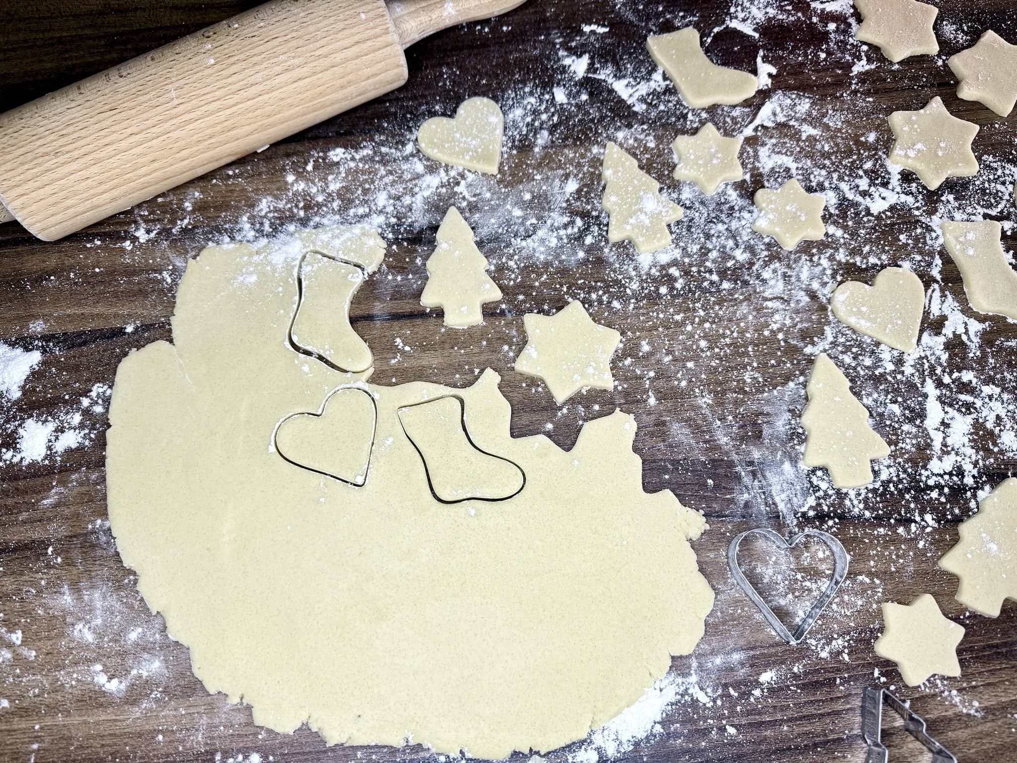 Cutting biscuits using Christmas-themed cutters