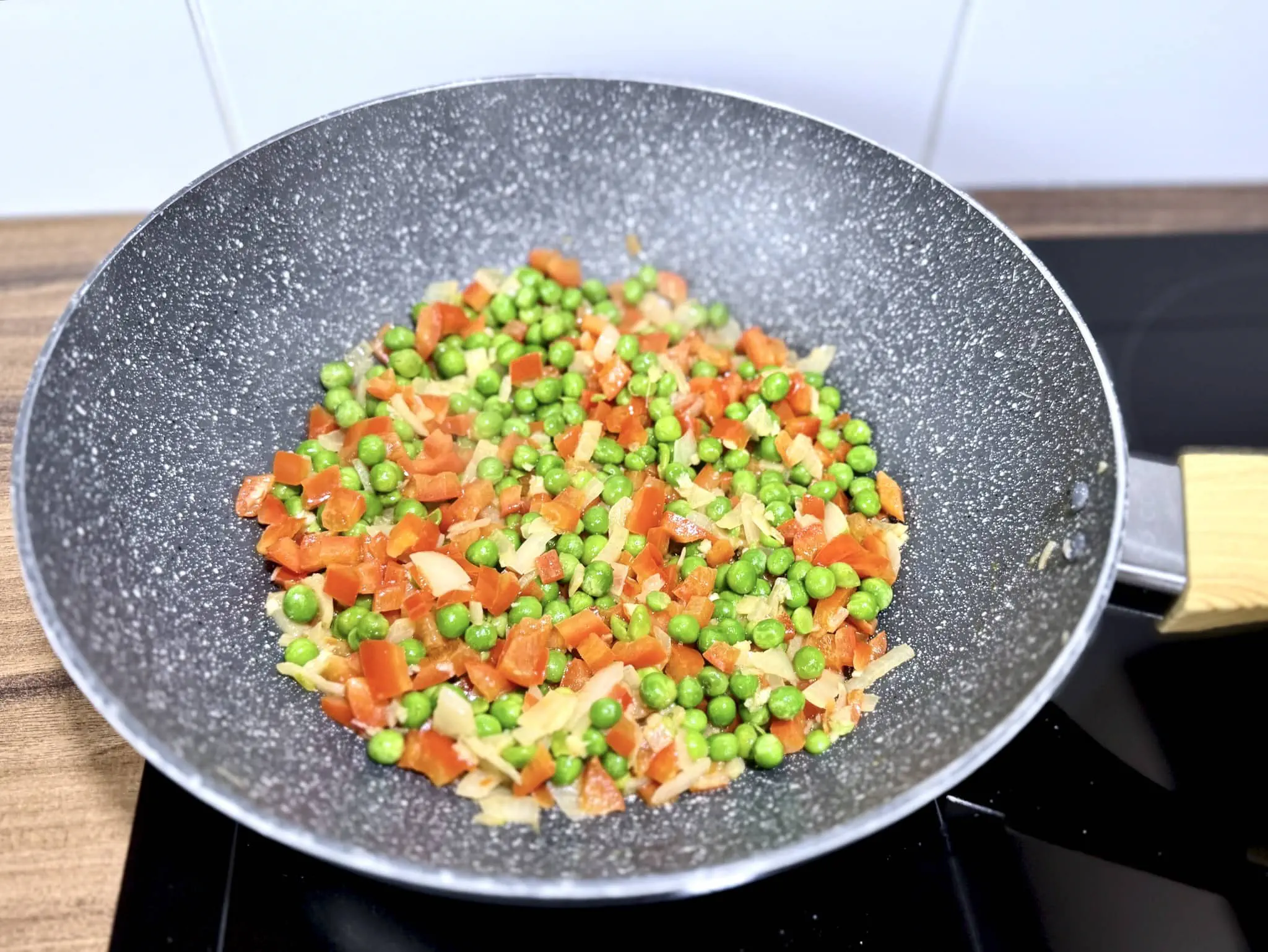 Frozen peas added to the pan