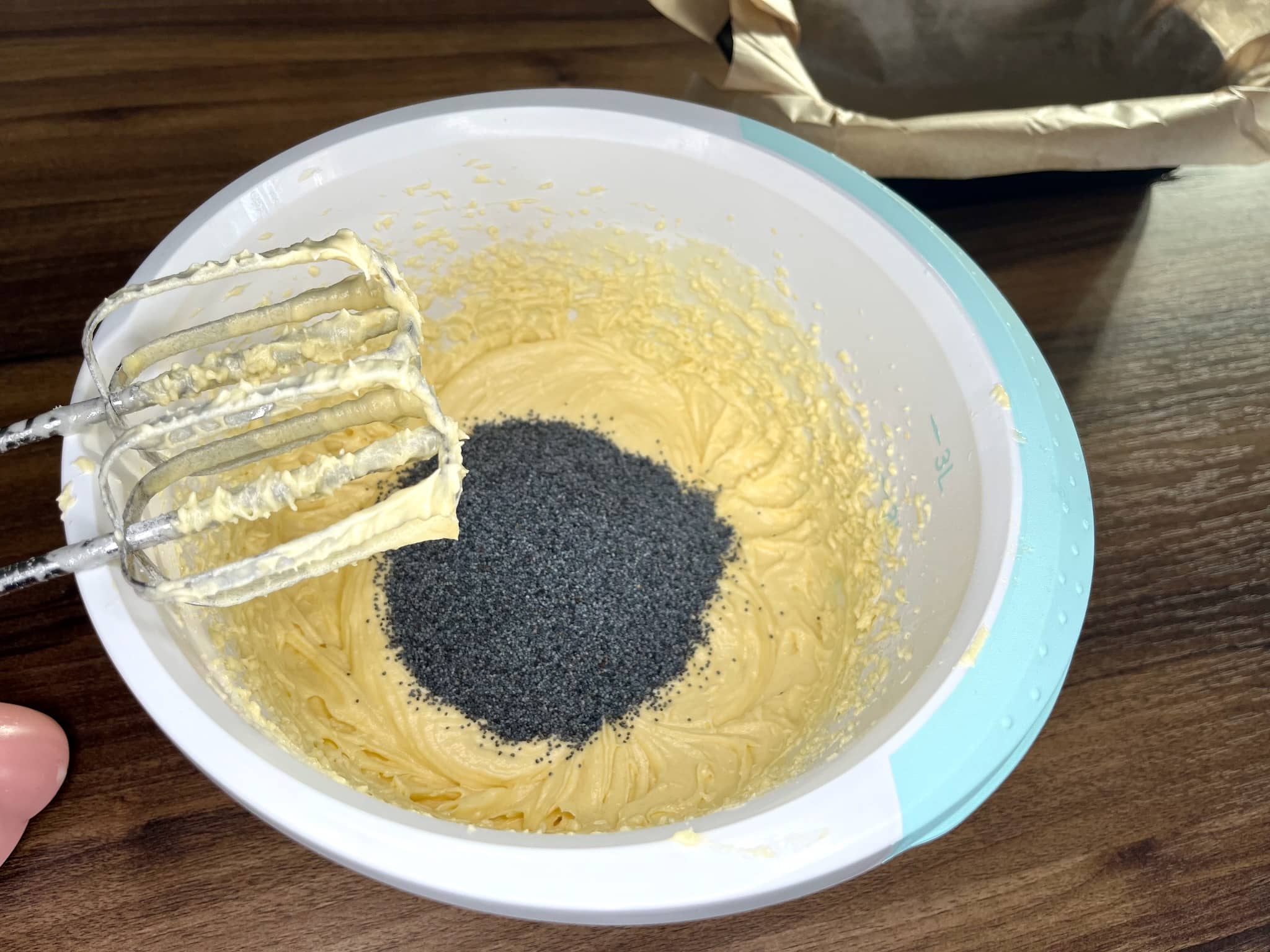 Beat eggs and sugar together in a bowl, then add poppy seeds