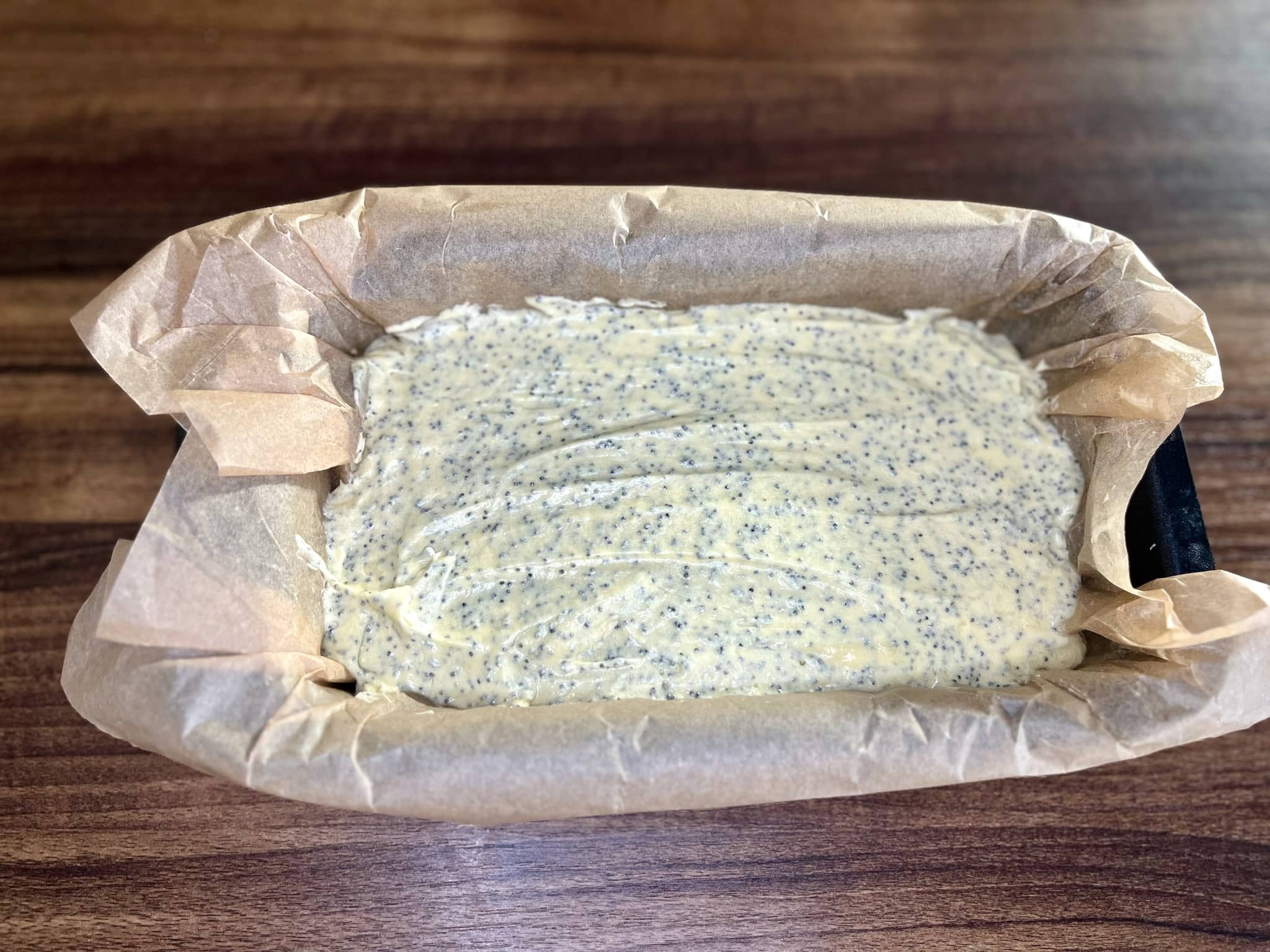The poppy seed loaf cake dough was transferred to a loaf pan.
