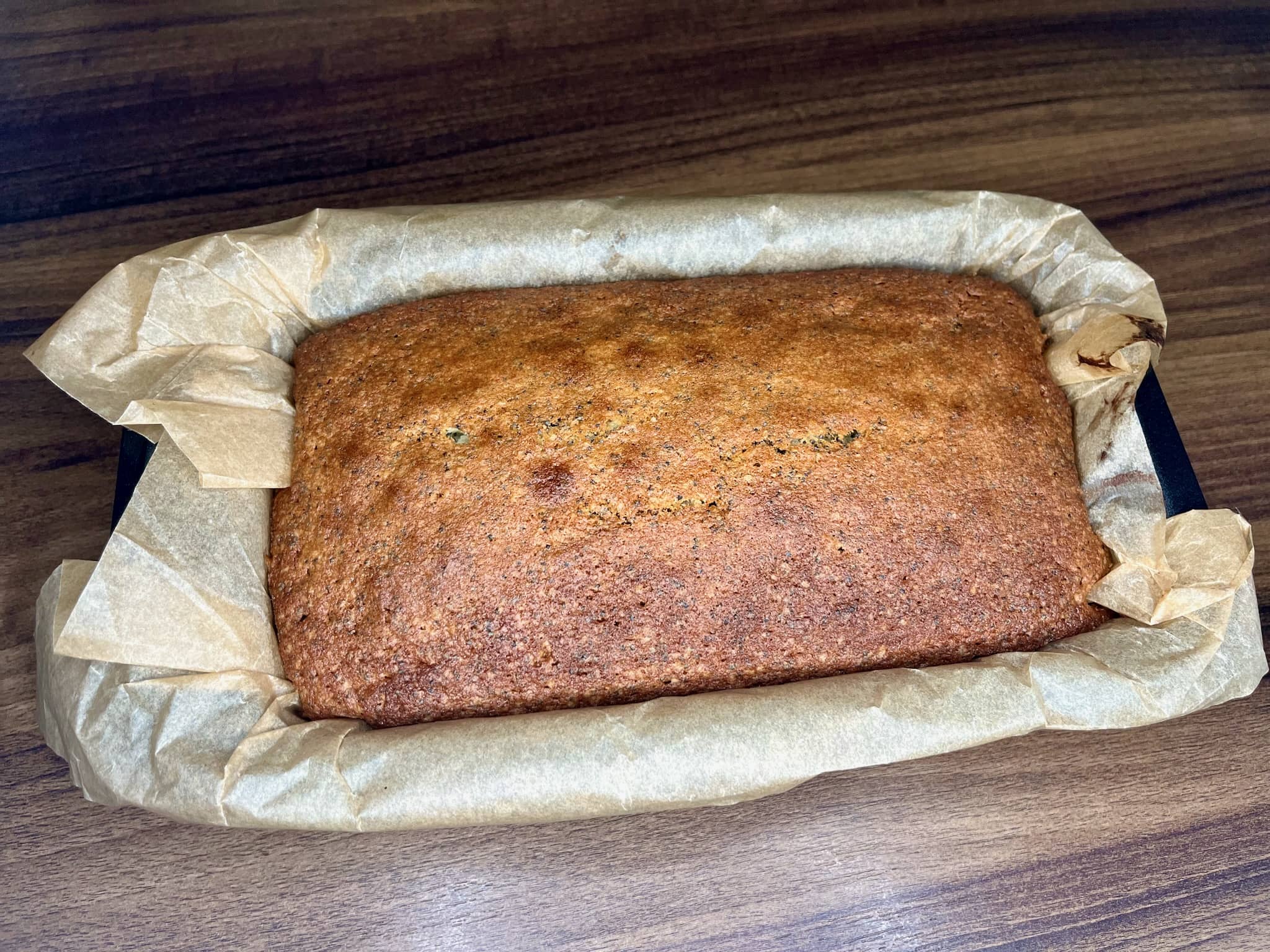 A freshly baked poppy seed loaf cake, still warm from the oven