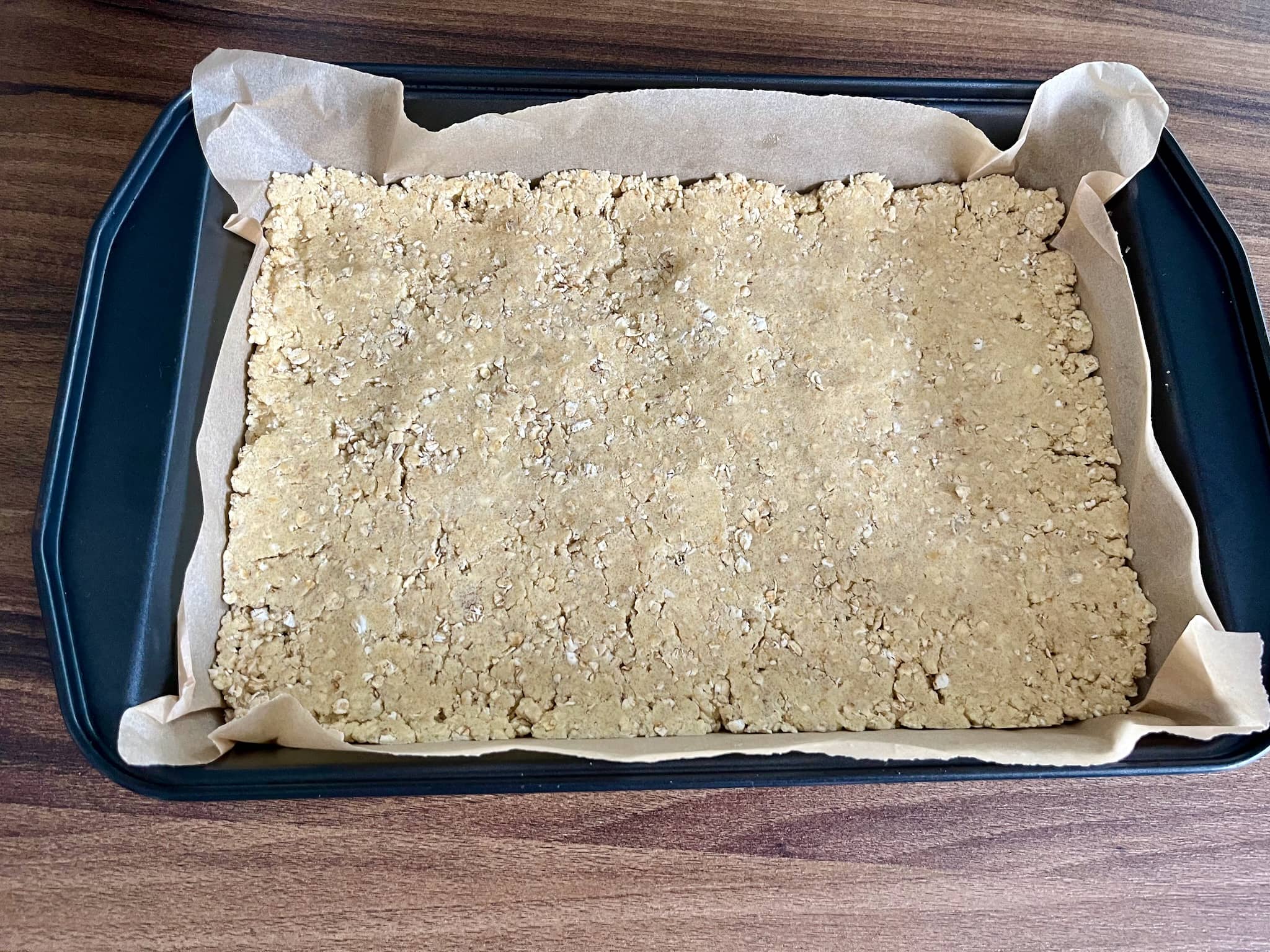 Oat dough flattens and even out in the tray
