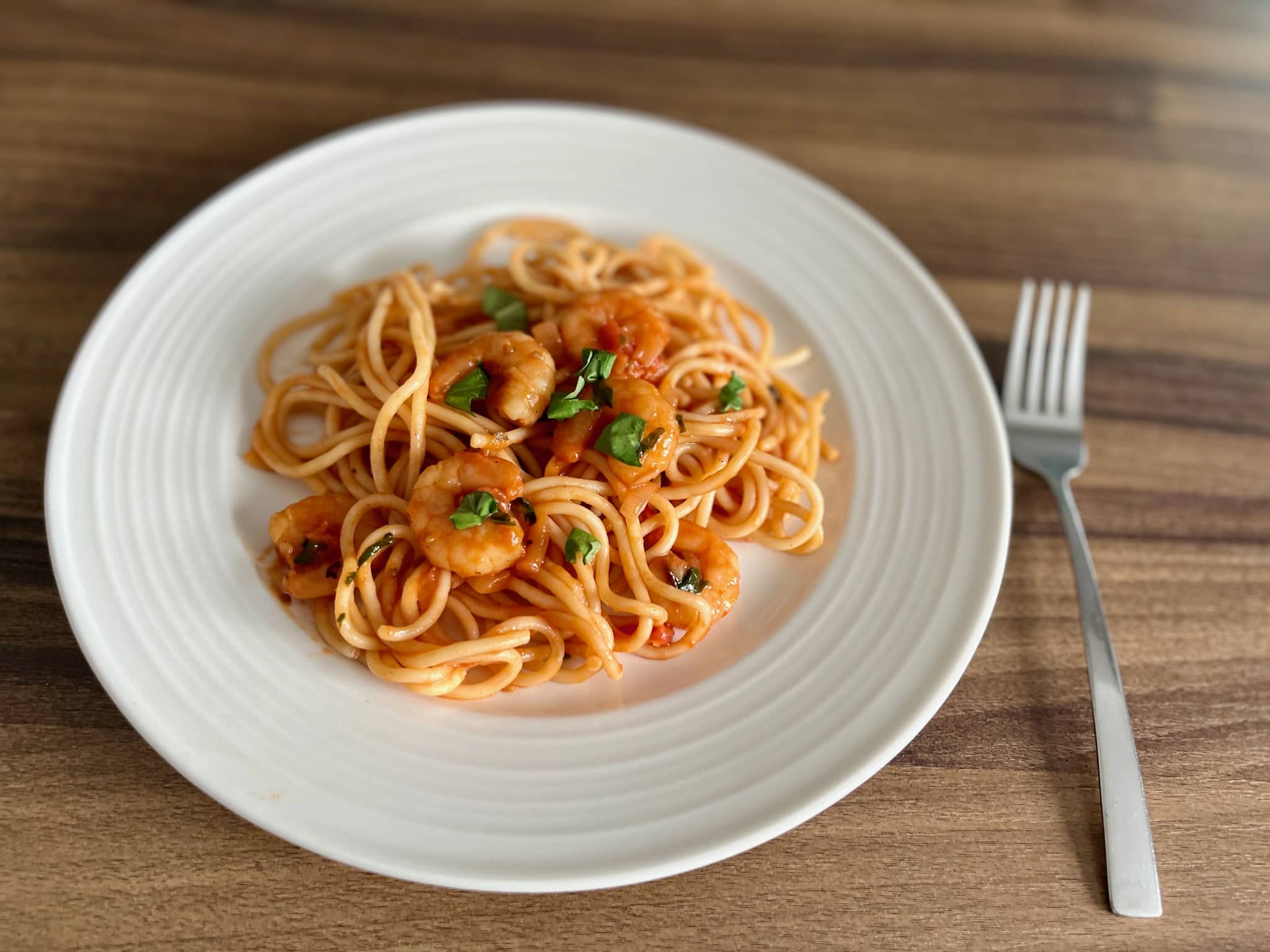 Tomato and Basil Prawns Pasta served on a plate