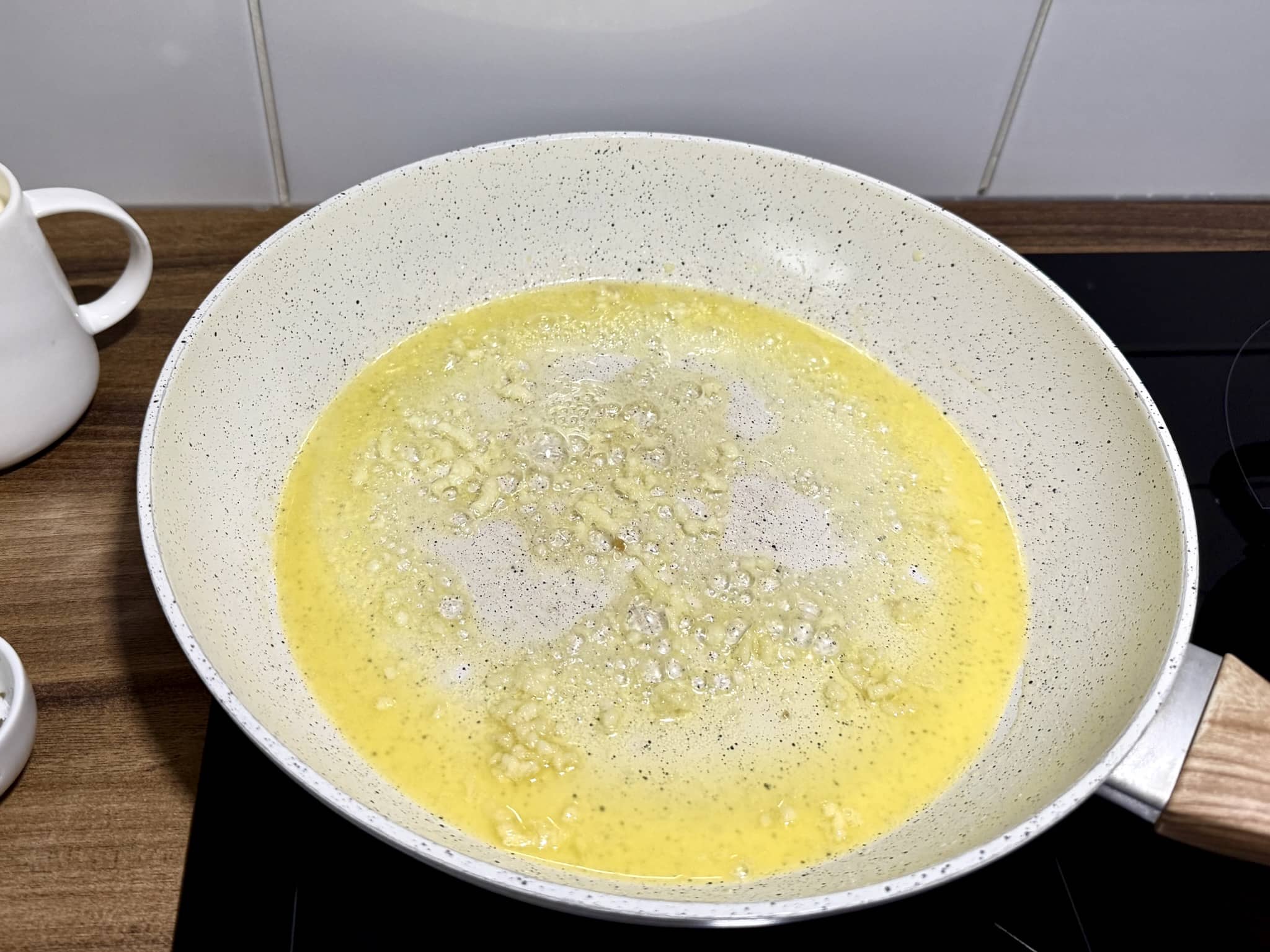 Melted butter with minced garlic sautéed in a pan until fragrant