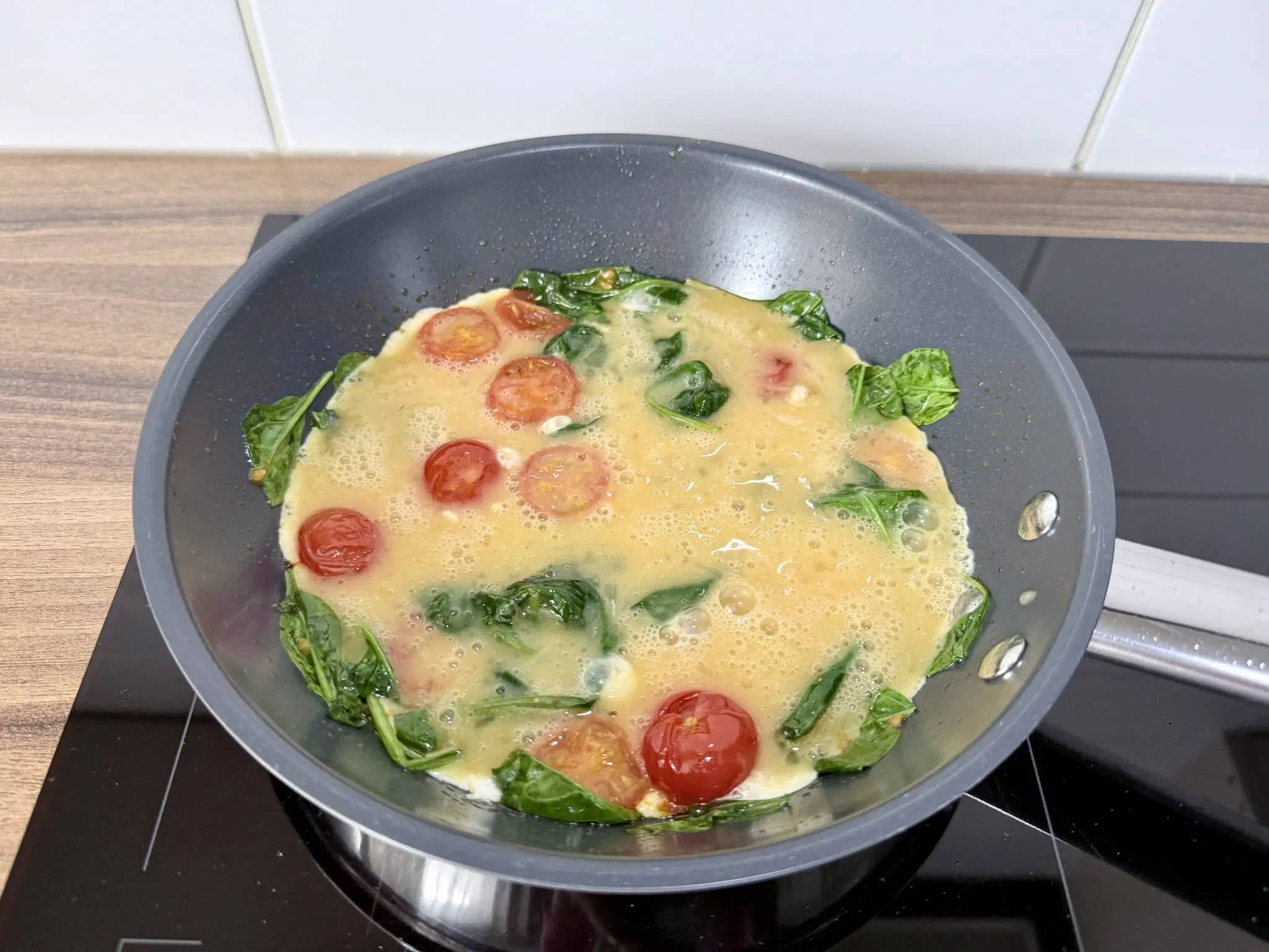 Egg mixture added to the pan shaping out an omelette