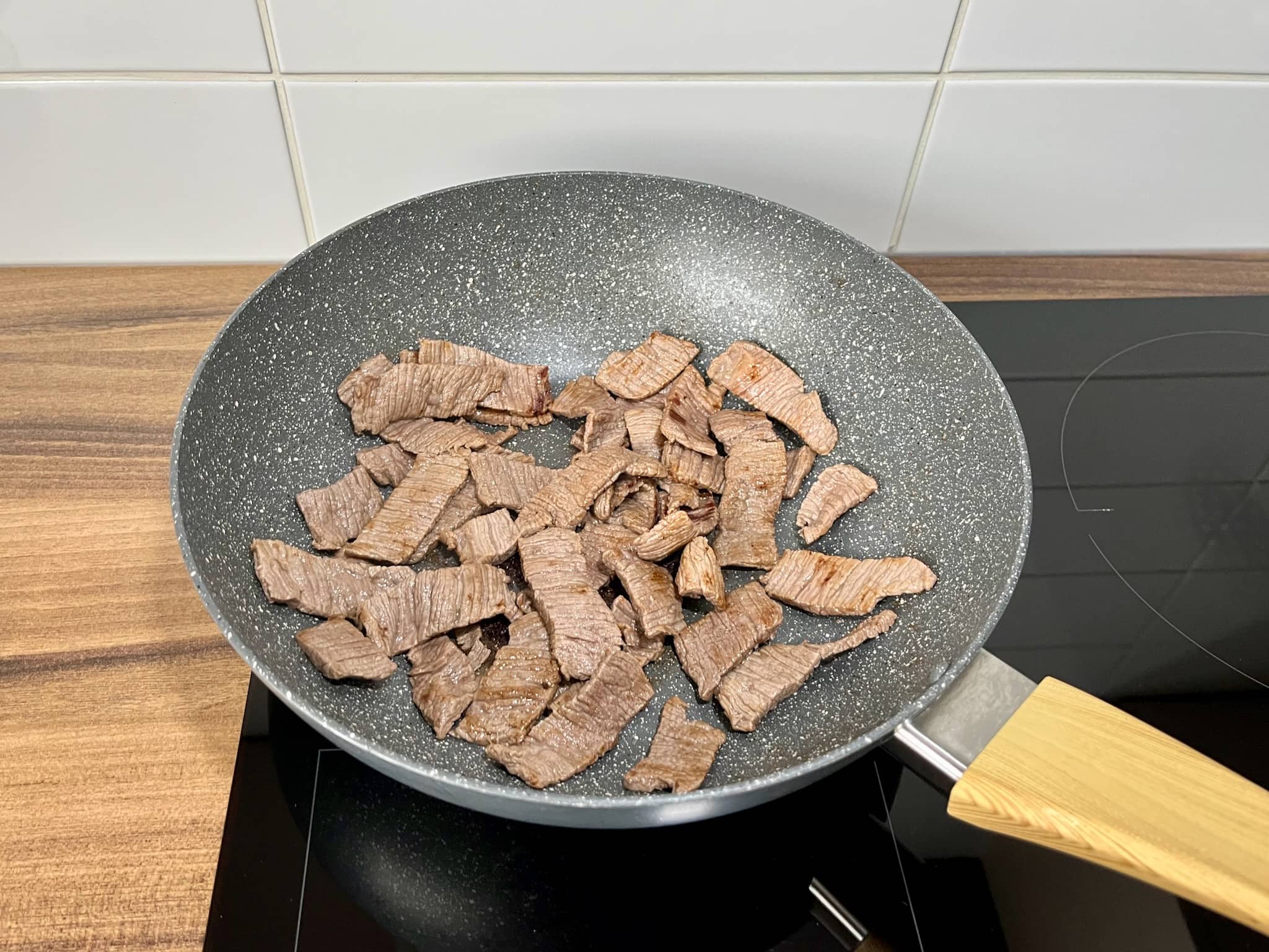 Steak meat slices, cooked to perfection, in a large skillet