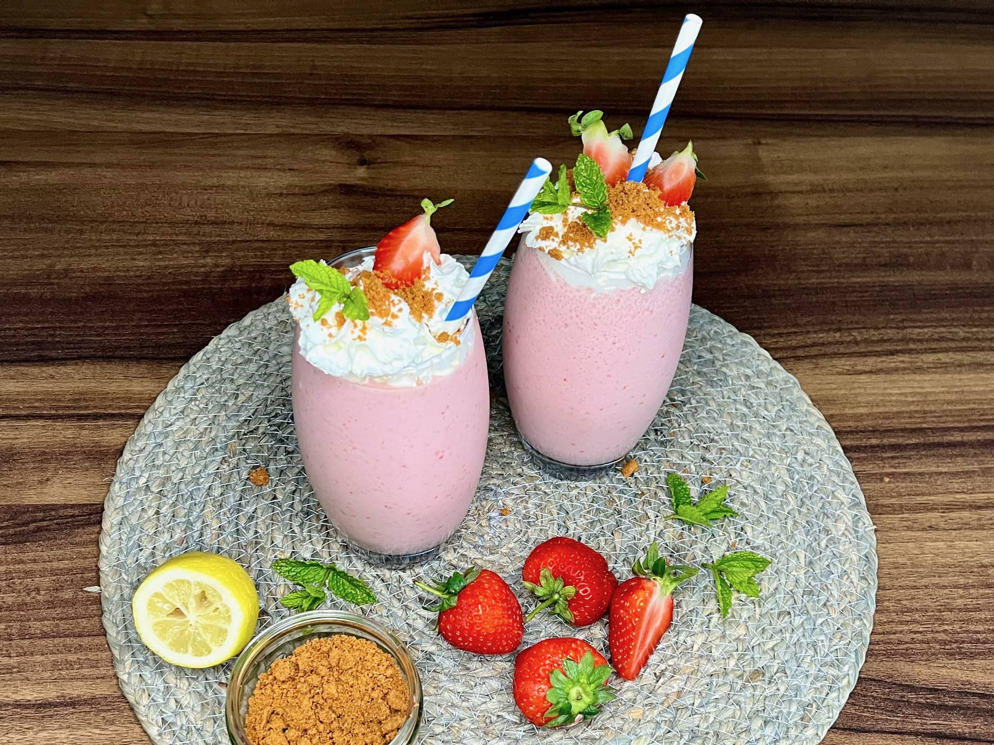 Served strawberry cheesecake smoothie in tall glasses