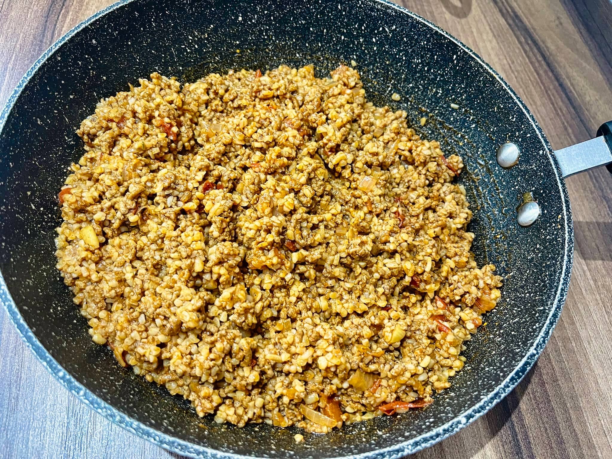 Meat mixed with bulgur in a pan