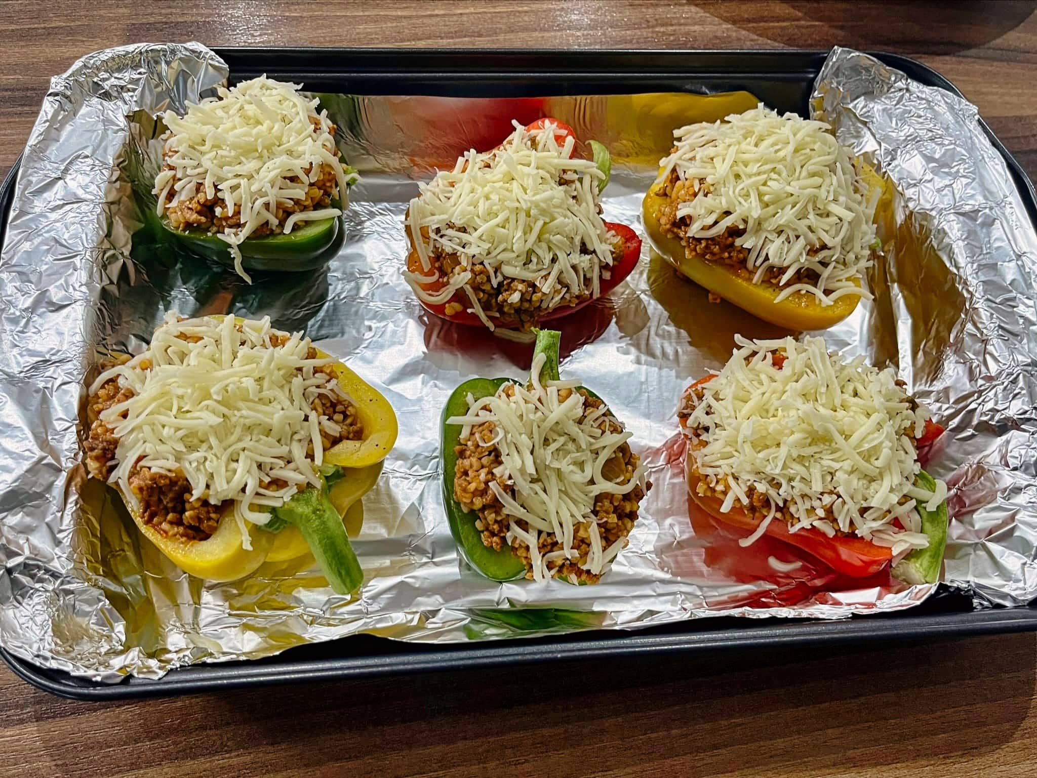Peppers stuffed with filling and covered with mozzarella cheese