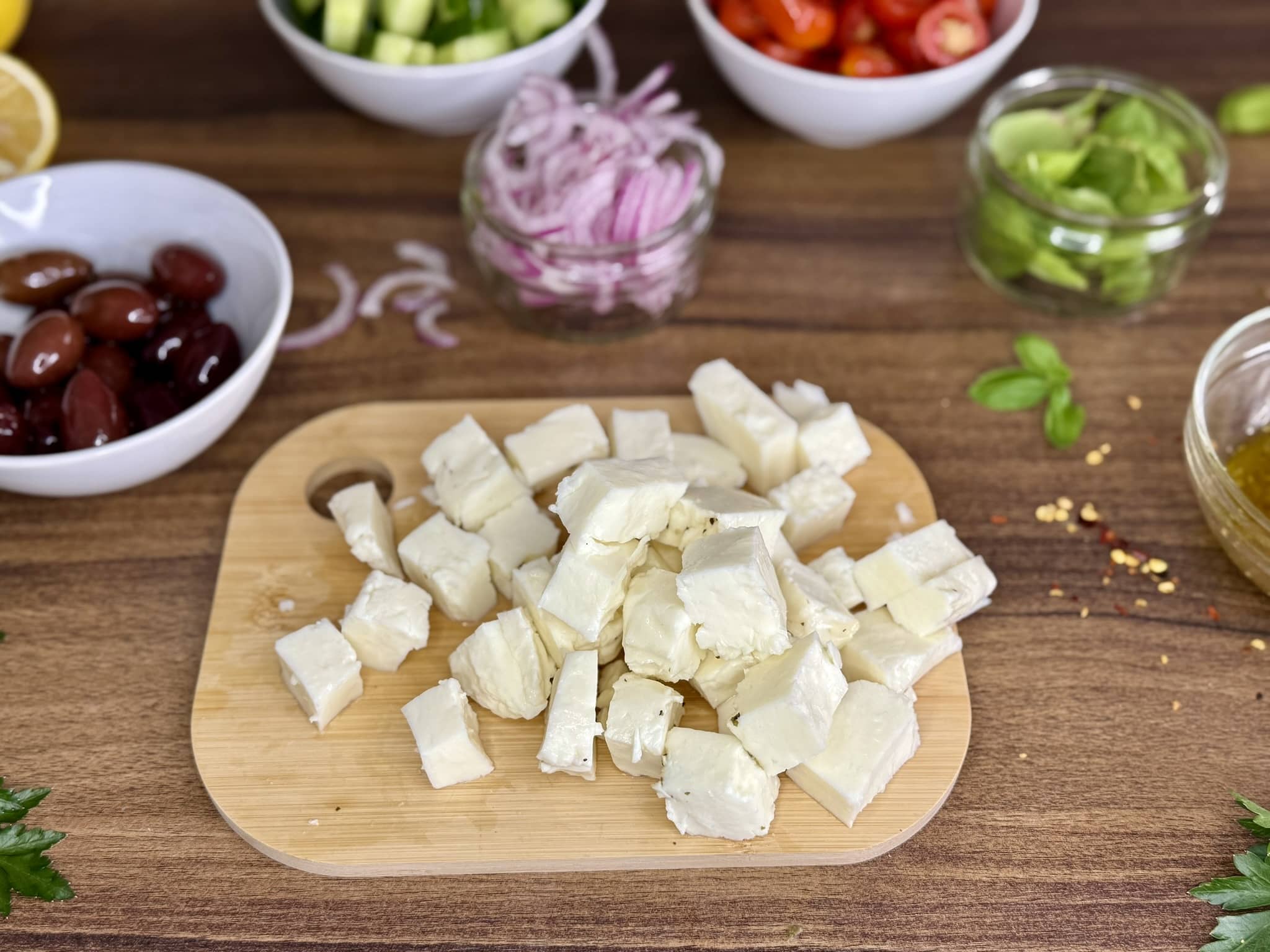 Halloumi cheese chopped into small cubes on a chopping board