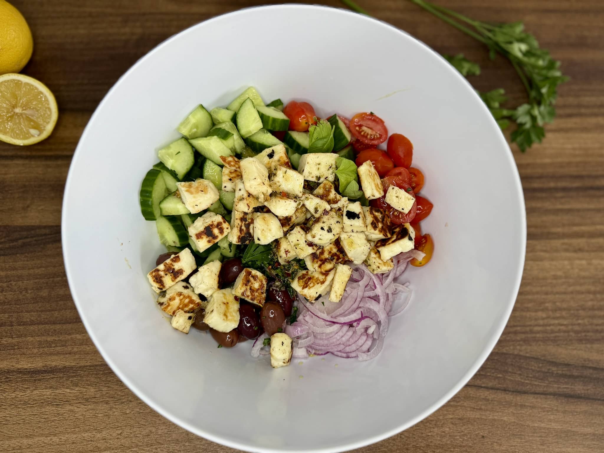 All ingredients of the Summer Halloumi Salad in a mixing bowl ready for a final toss