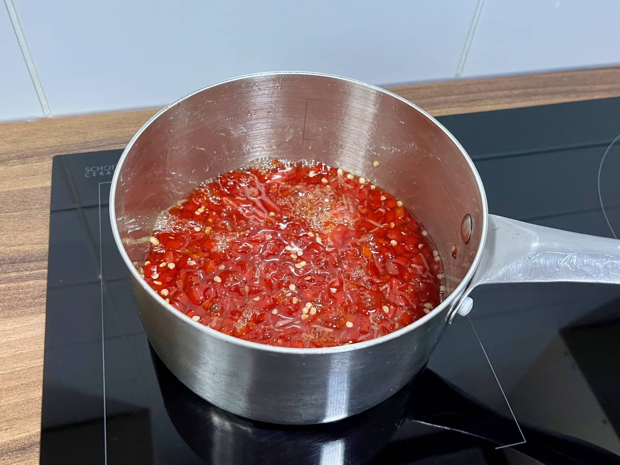 All ingredients for Sweet Chilli Sauce in a pan simmering