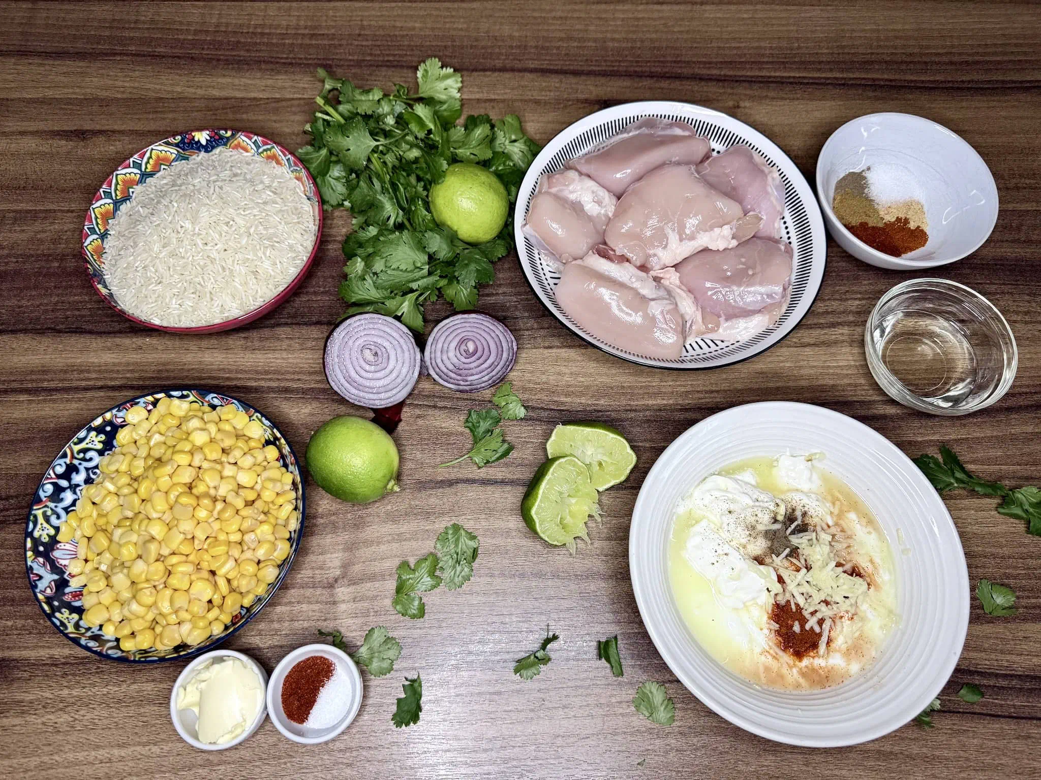 All raw ingredients arranged on a tabletop, ready to make a Sweetcorn and Chicken Rice Bowl