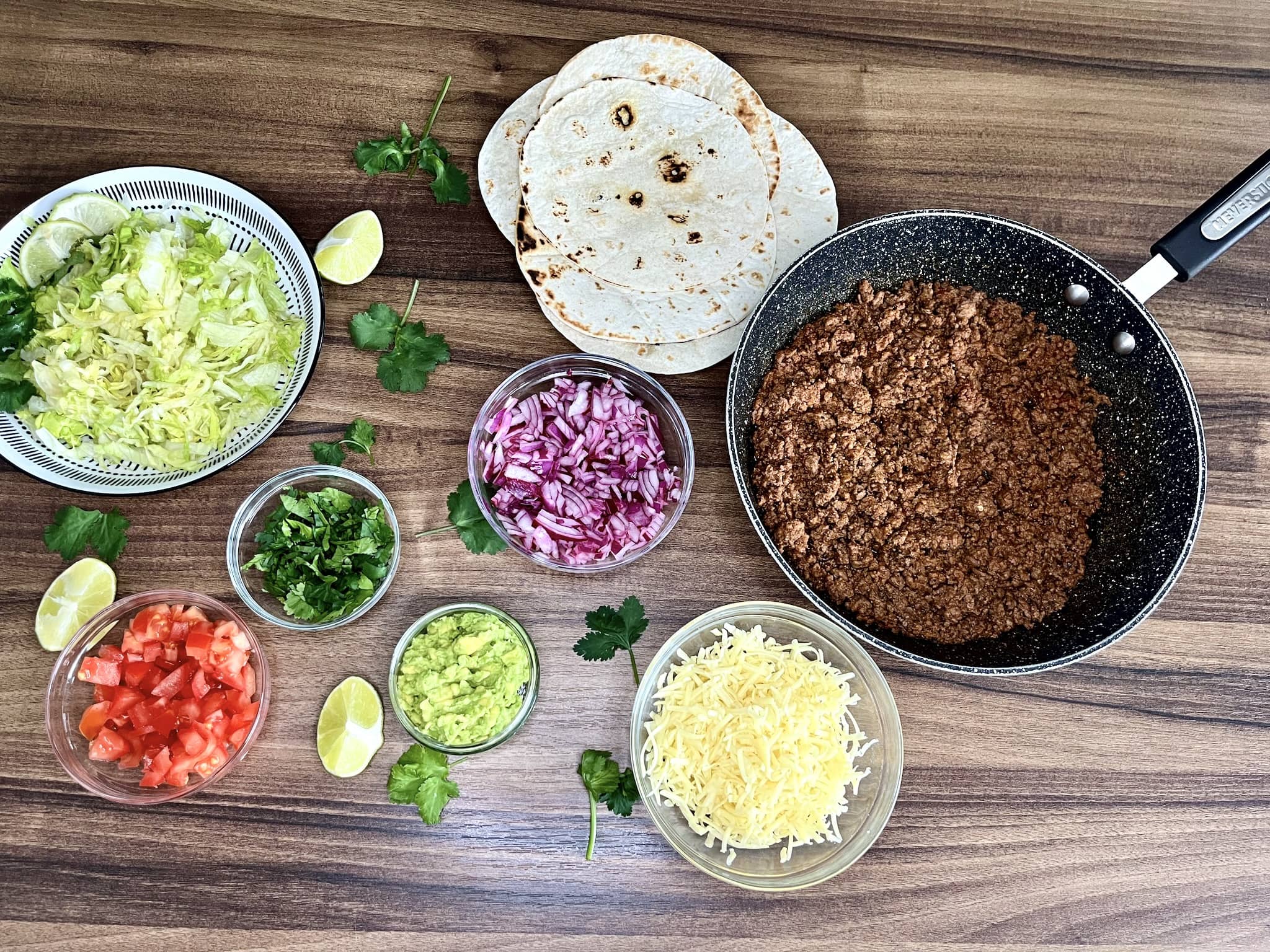 All the ingredients laid out on a tabletop, ready to assemble mini wraps
