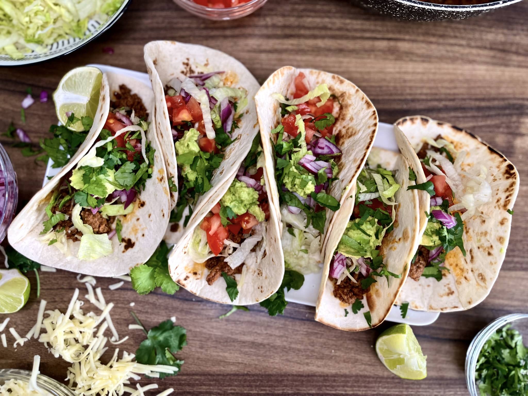 Six neatly assembled and half-folded Taco-Style Beef Mince Mini Wraps on a serving plate
