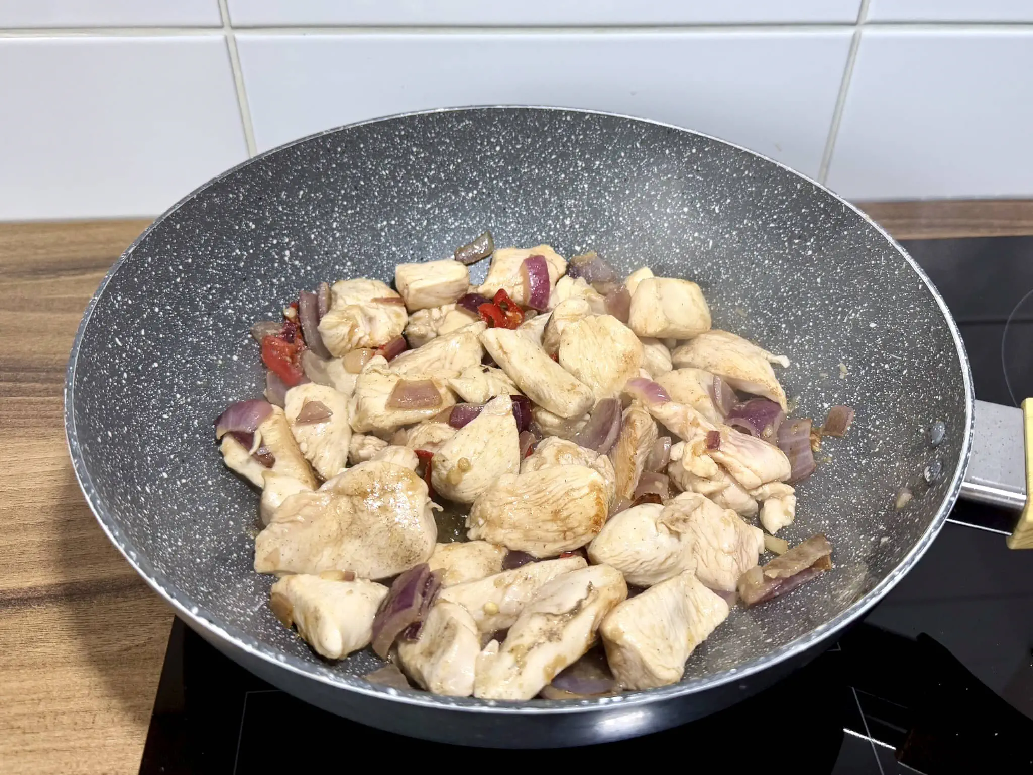 Nicely cooked diced chicken breast in a pan