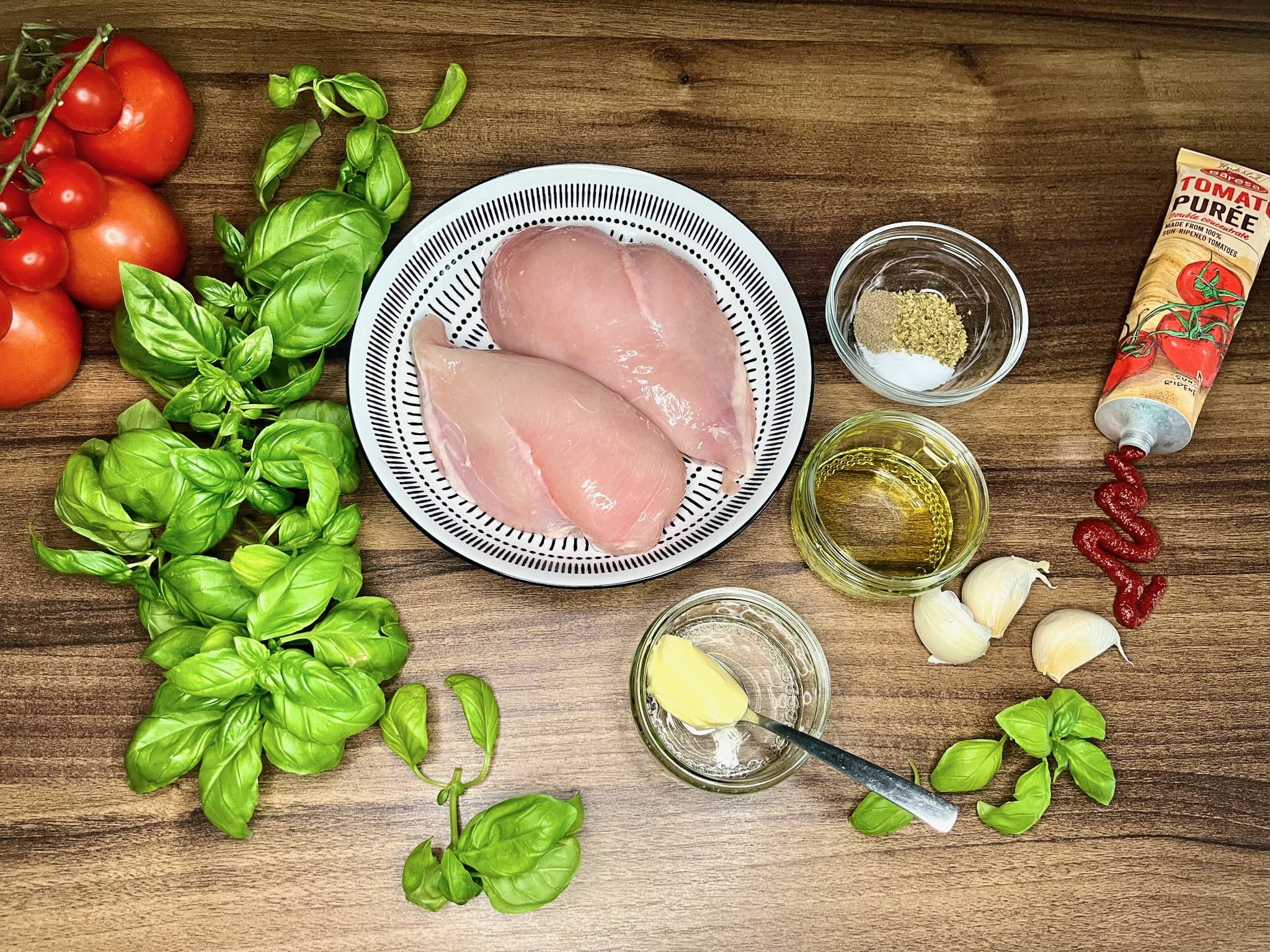 All ingredients are laid out on the tabletop, ready to prepare Tomato and Basil Chicken