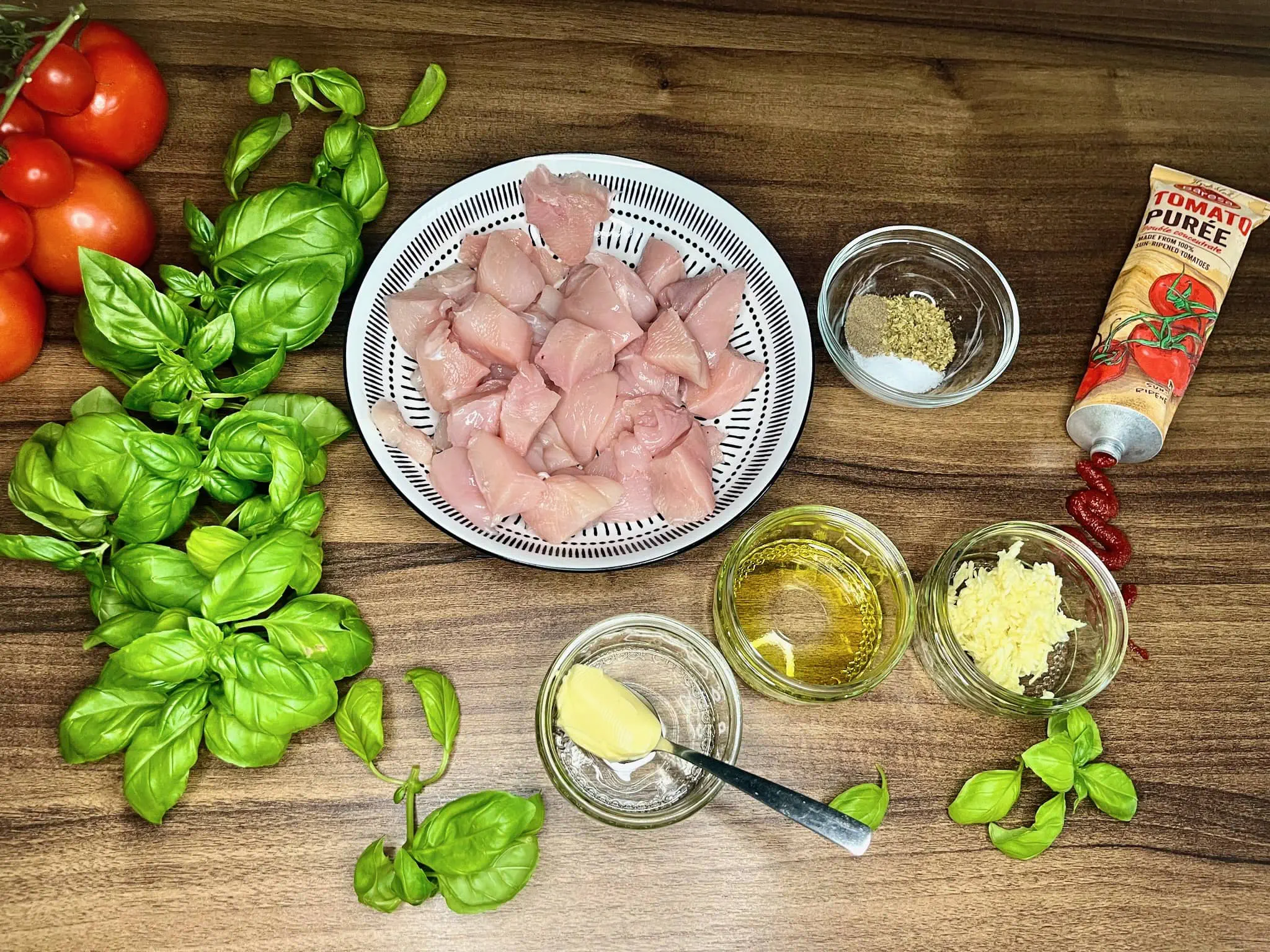 Chopped chicken breasts are in a bowl alongside the other ingredients on the tabletop