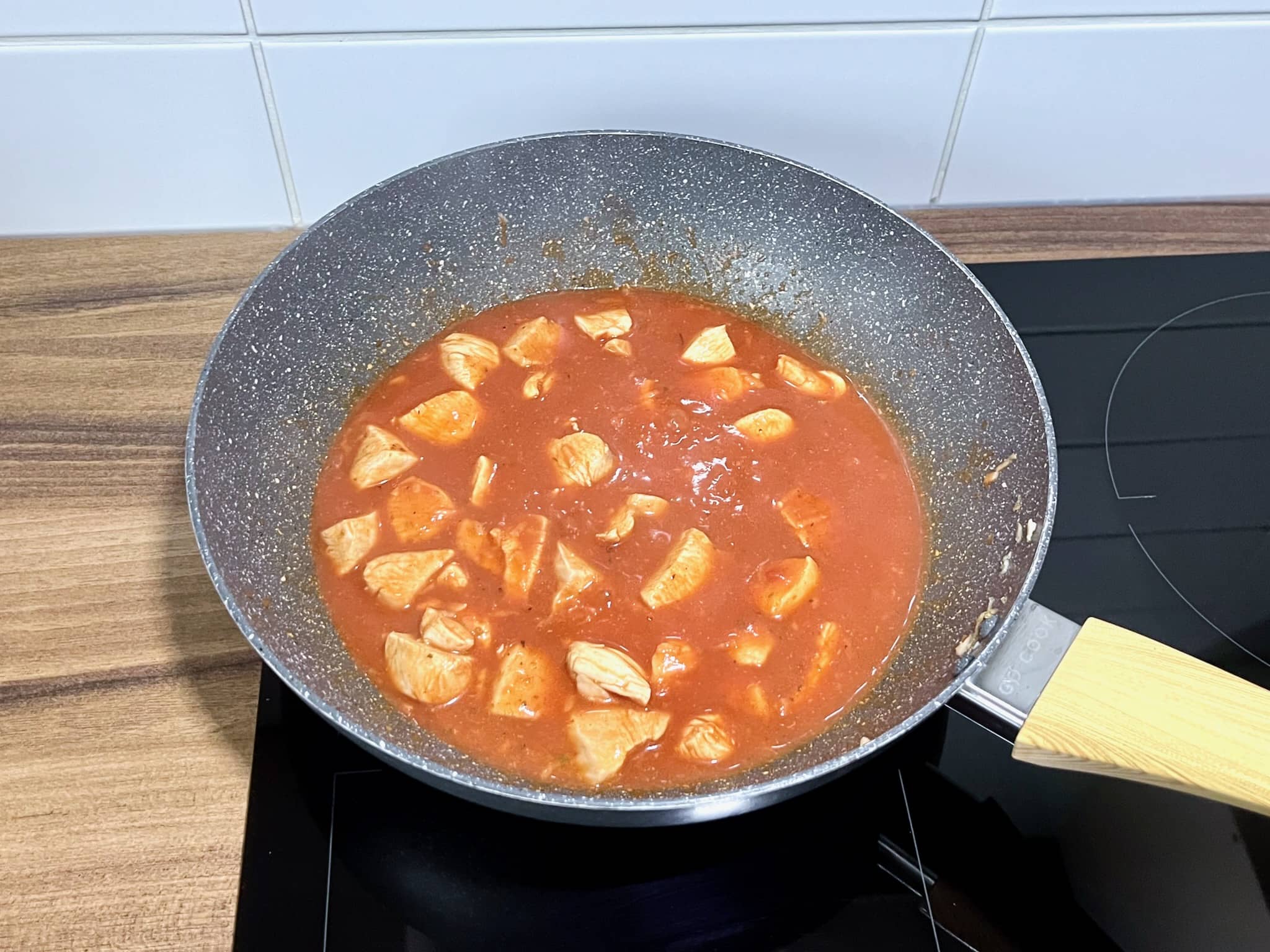 The chicken breasts are nearly ready and still in the pan