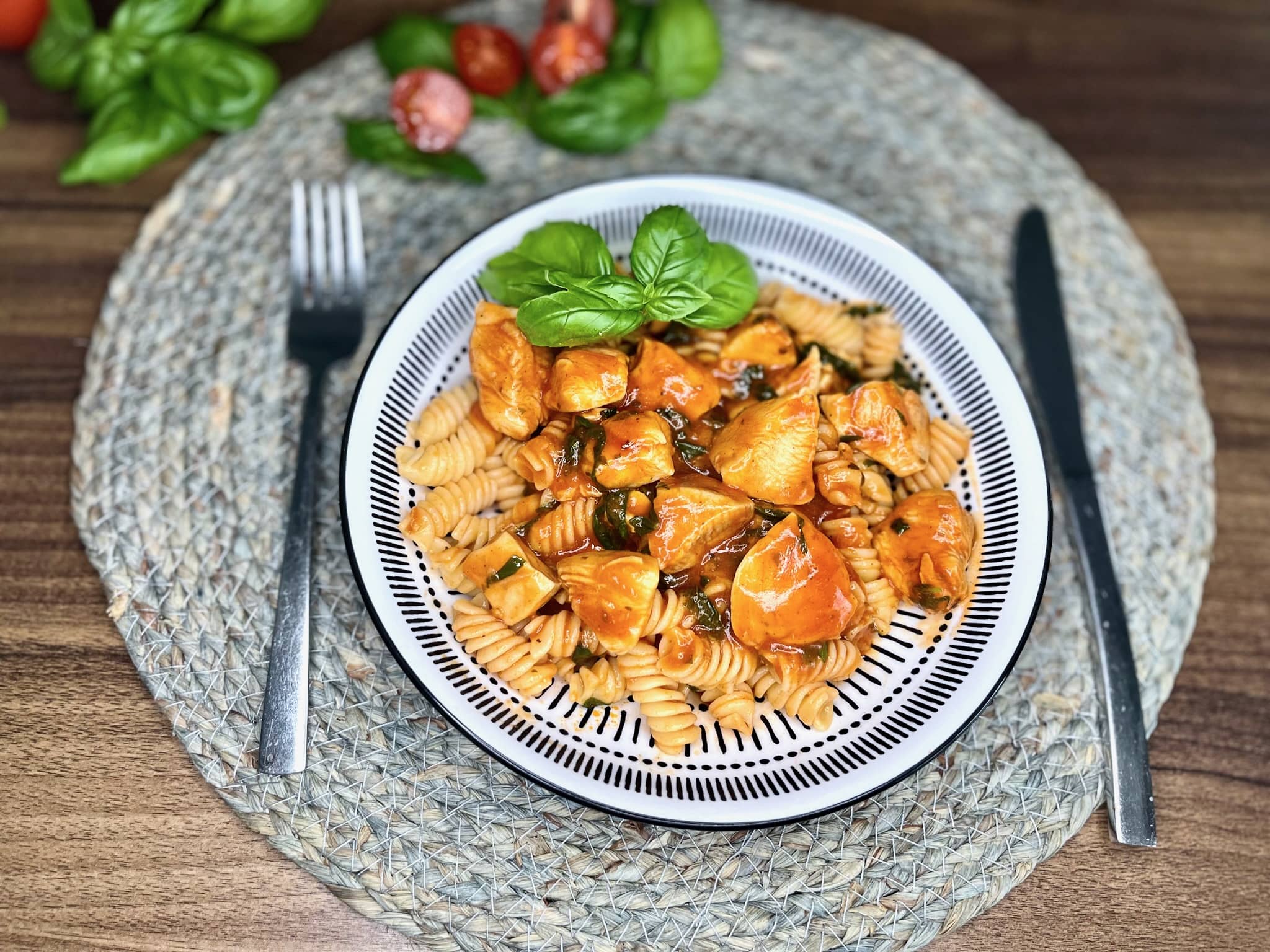 Tomato and Basil Chicken is elegantly served with pasta in a bowl
