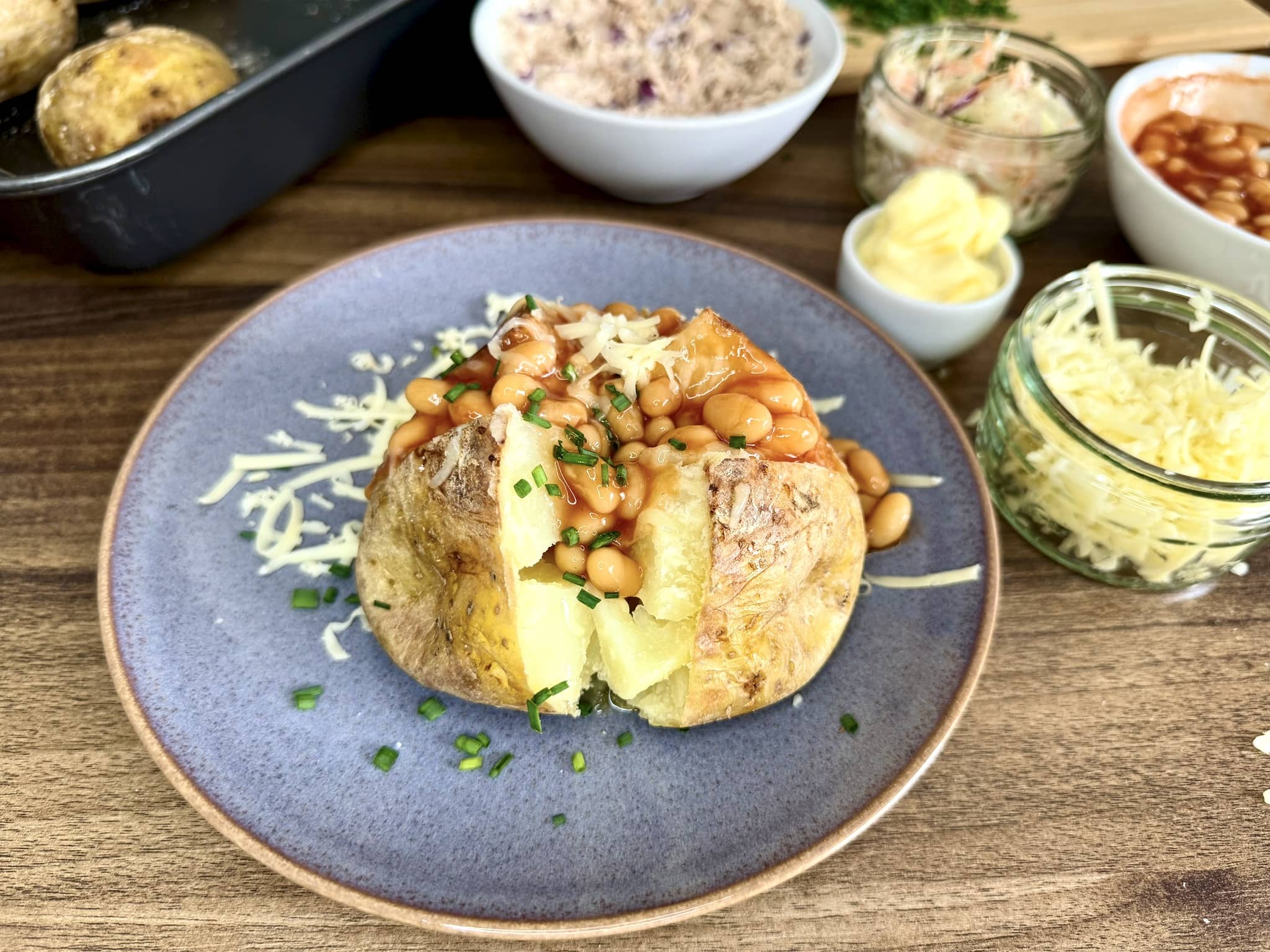 Beans added to the baked potato and sprinkled with chives