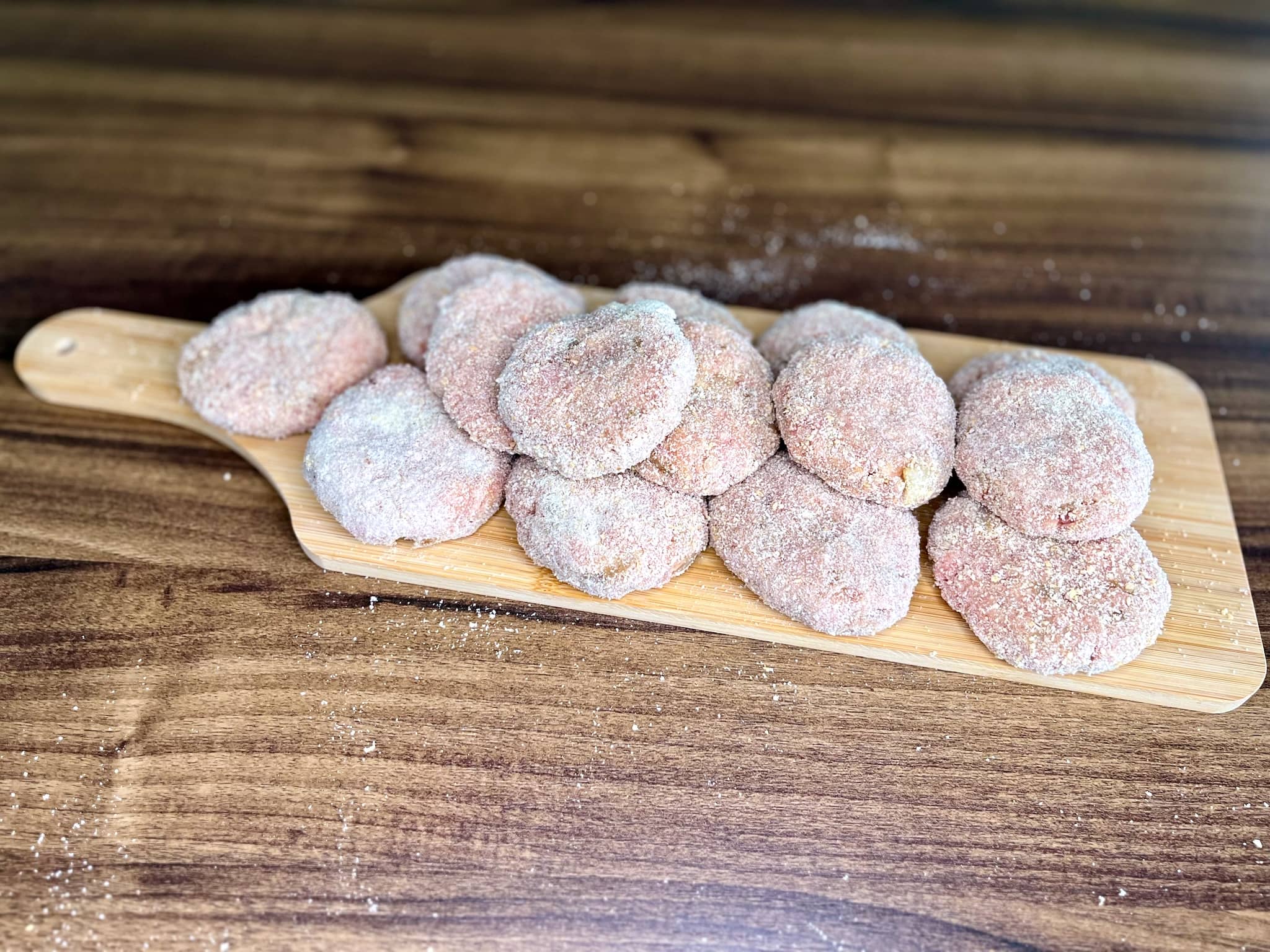 Formed Meat Patties on a chopping board before frying