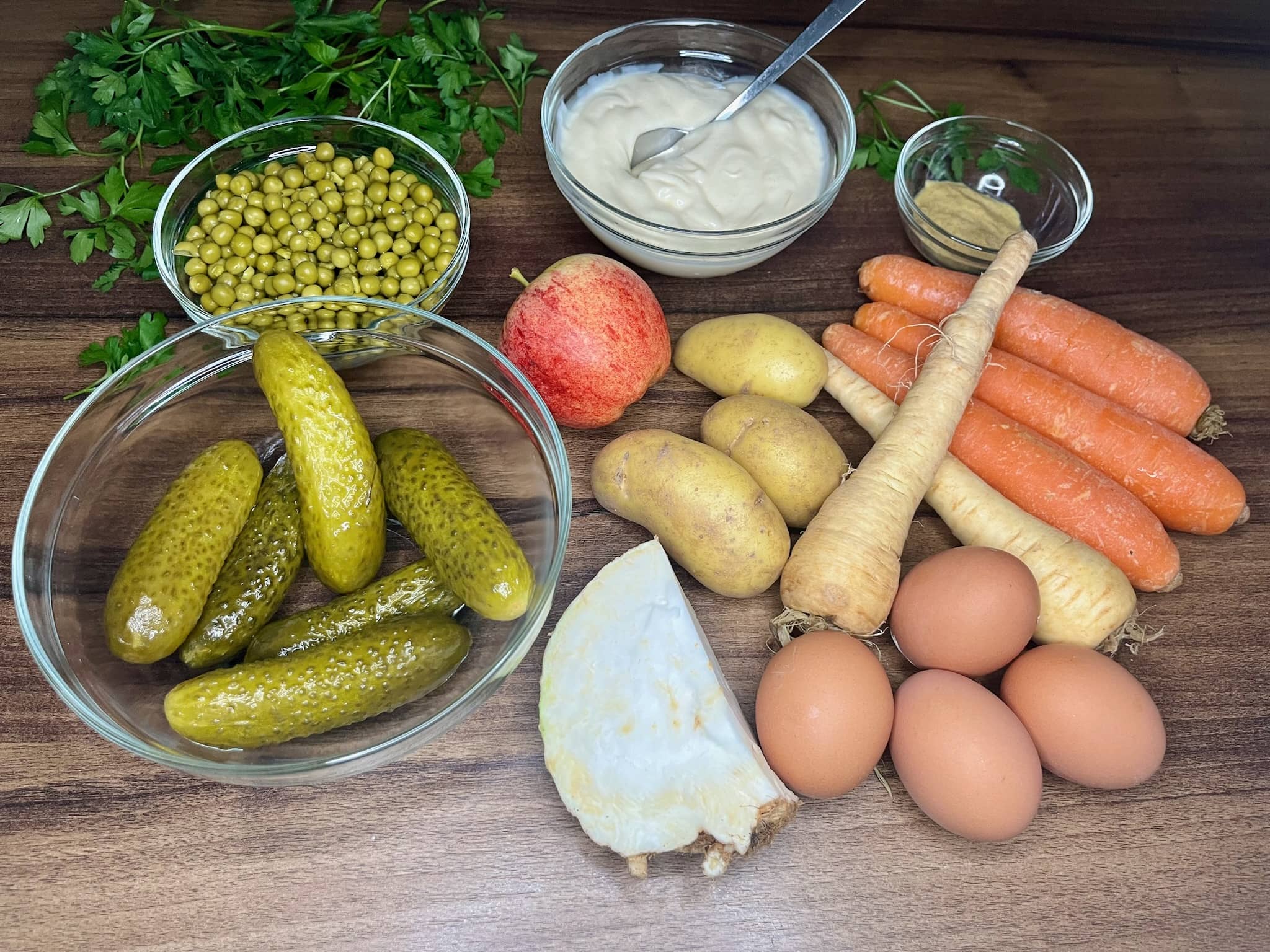 All the ingredients are neatly arranged on the tabletop, ready to make a Traditional Polish Vegetable Salad