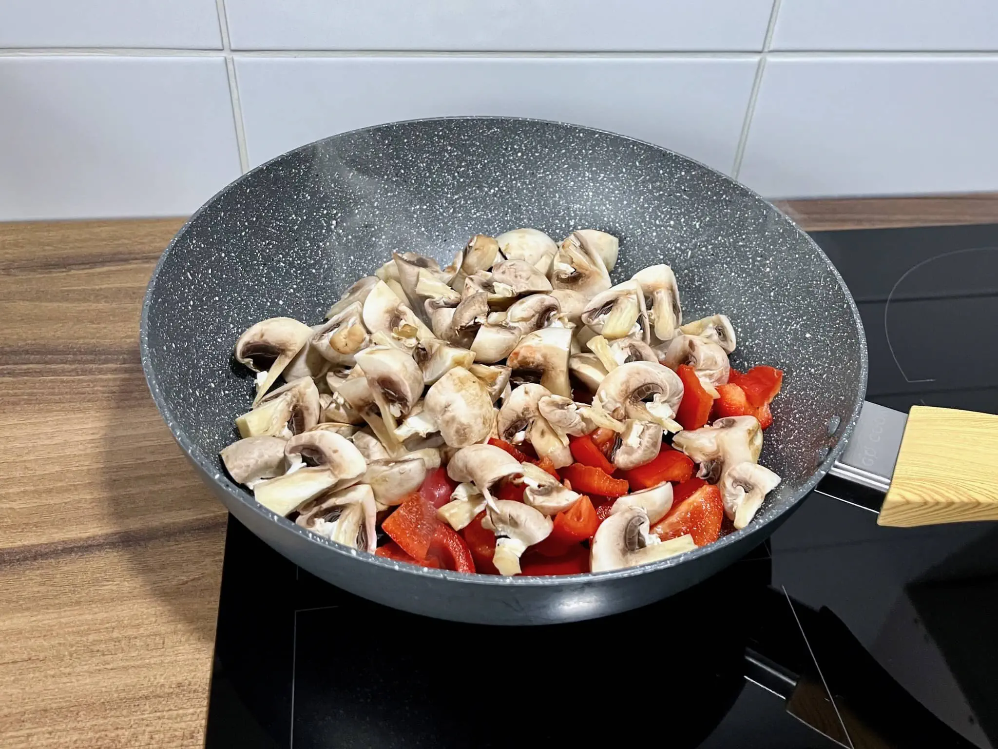 The vegetables are sizzling and popping in the hot oil